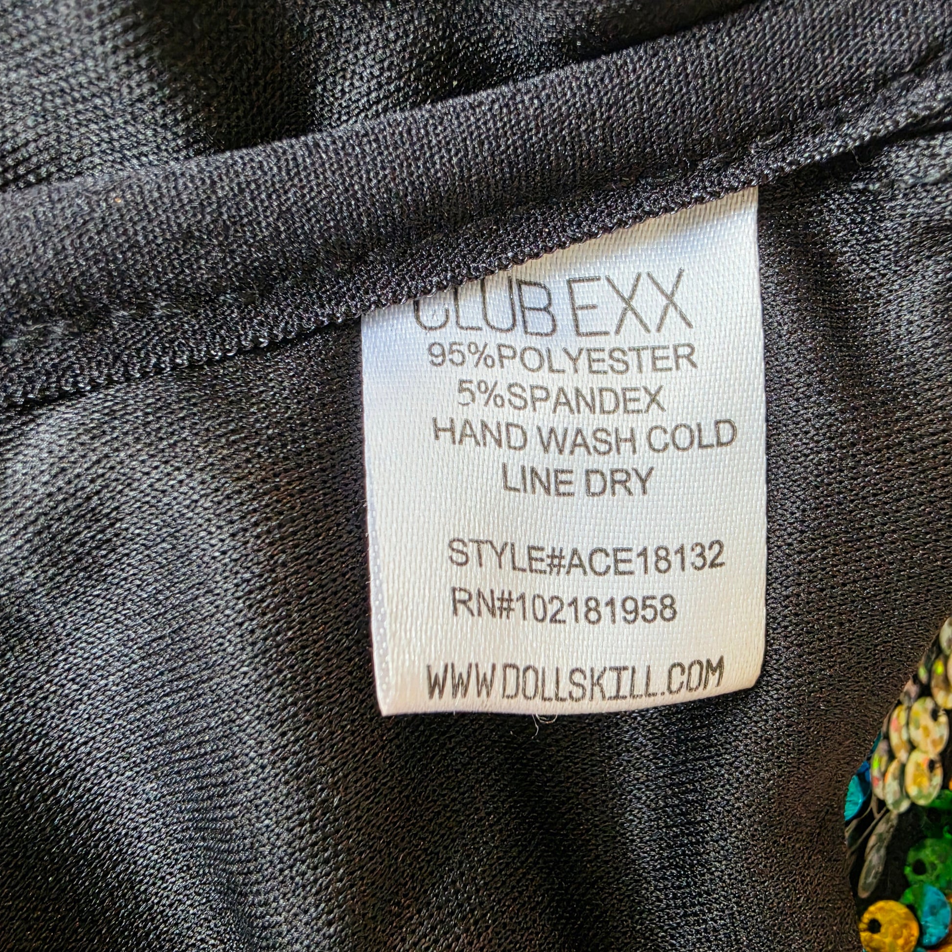Interior view of black lining and care label inside Club Exx sequin bodysuit