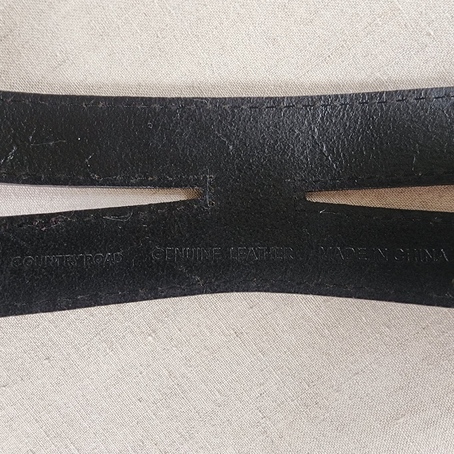 Close up of inside of Country Road belt showing brand, leather and where made details.