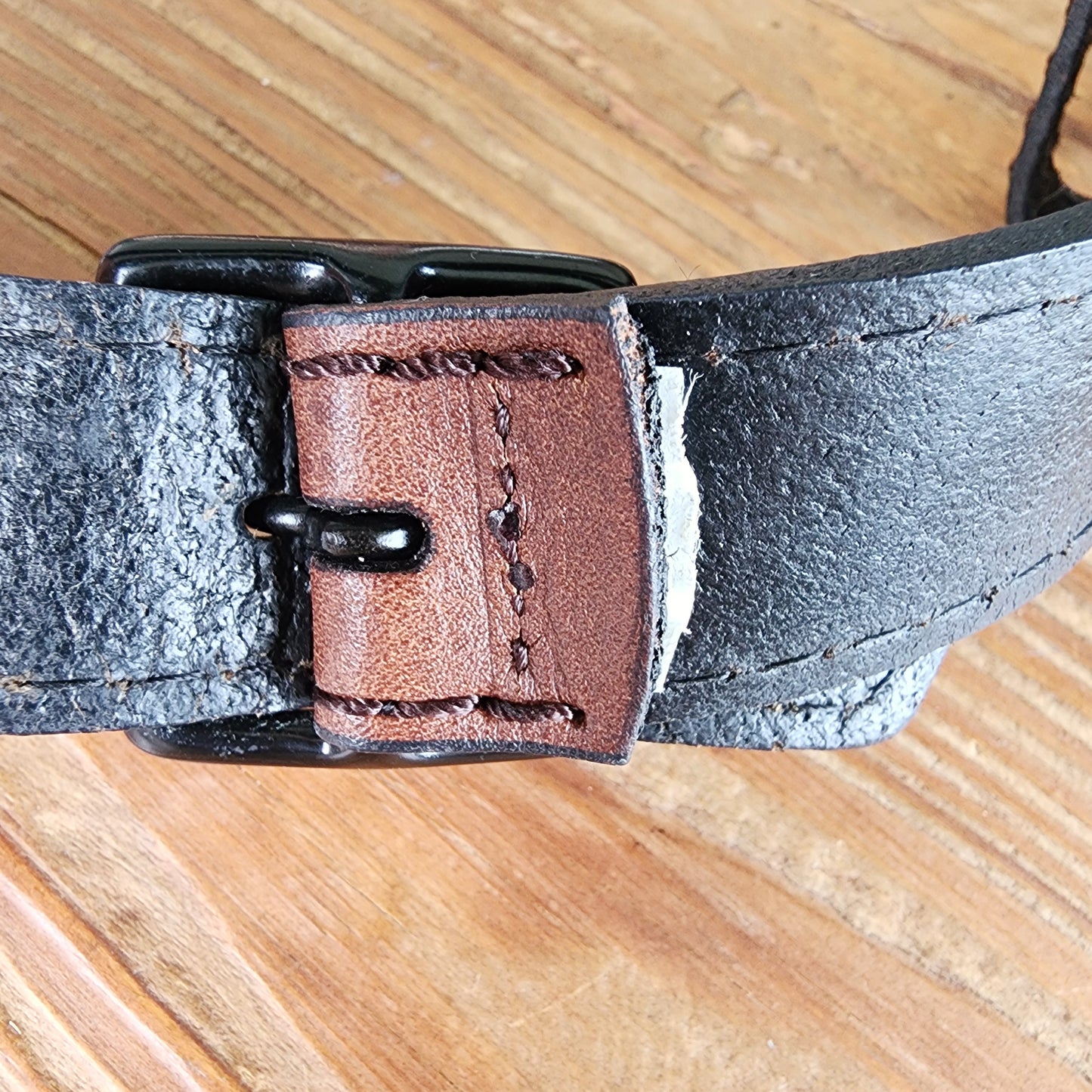 Close up showing the tag that has been removed on Country road triple buckle belt