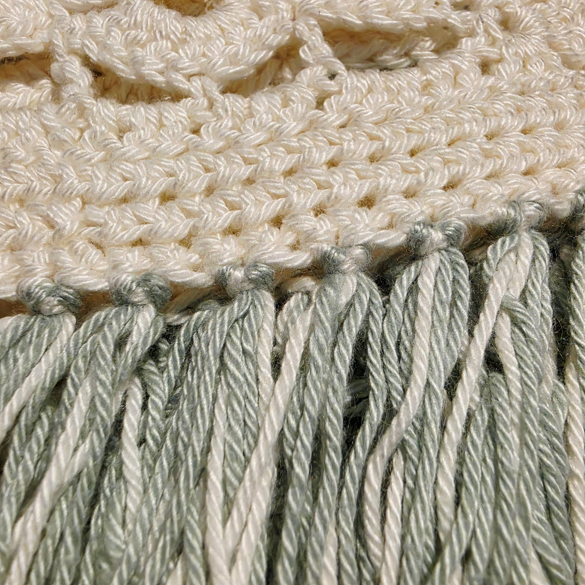 Close up vies of the fringe details on the crochet fringe dress, showing the quality of the piece.