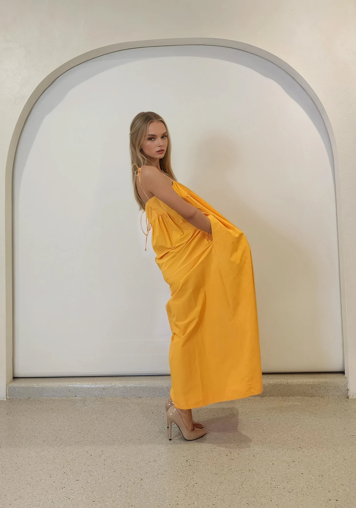 Side angle of the marigold midi dress, highlighting the volume and drape of the fabric.