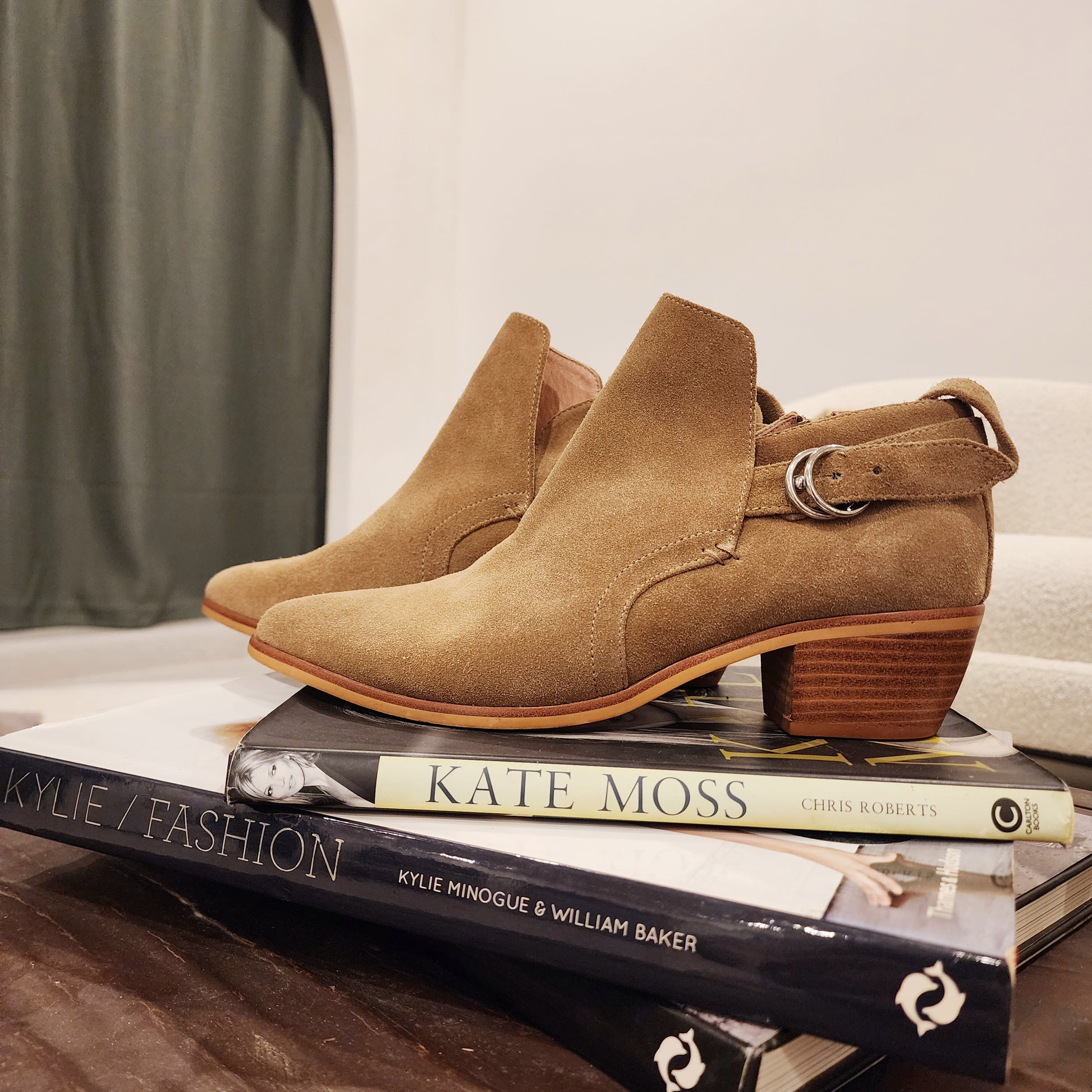 Image showing the side view of the Dept. Of Finery brand, suede ankle boots, showing the buckle details and Cuban heel style.