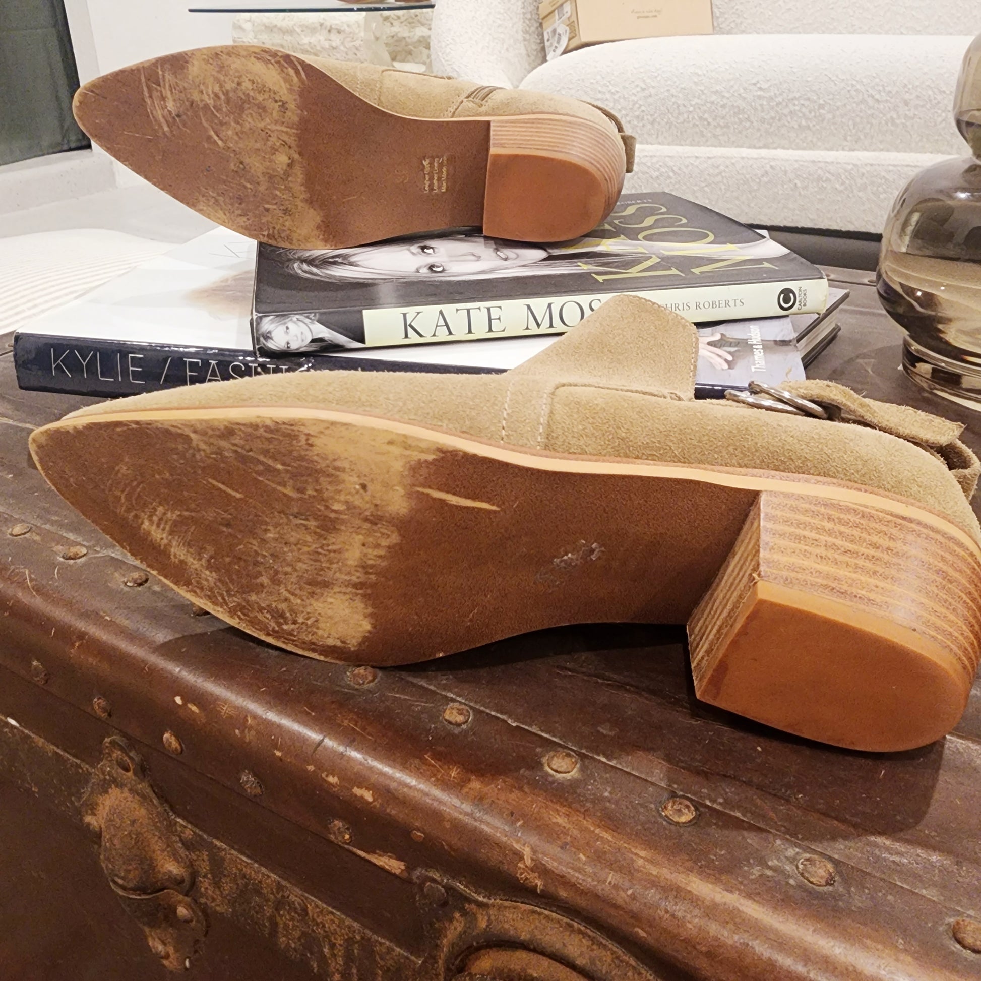 Image showing the bottom view of the Dept. of Finery suede ankel boots, showing the wear on the soles and minor wear to the heel.