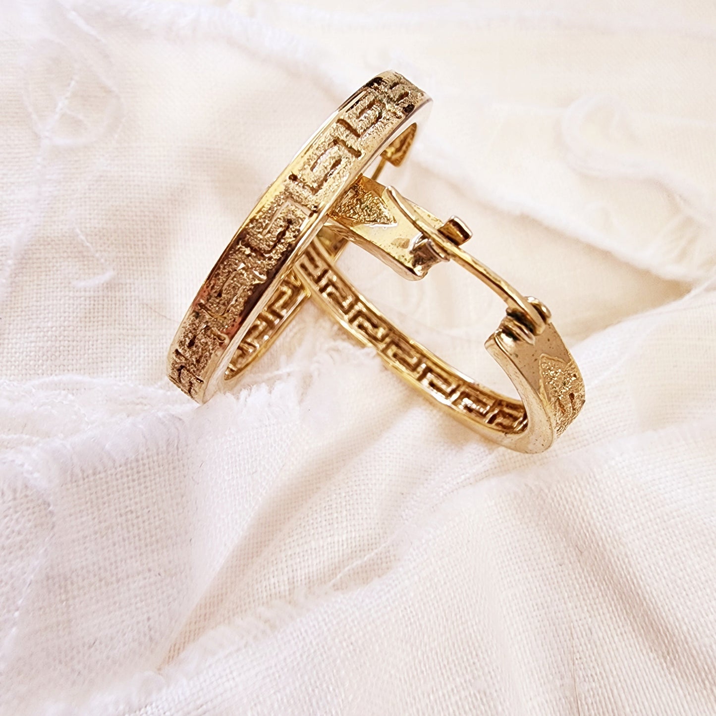 Close-up of the Desert at Dusk hoops highlighting the textured border and dusk-inspired gold sheen.