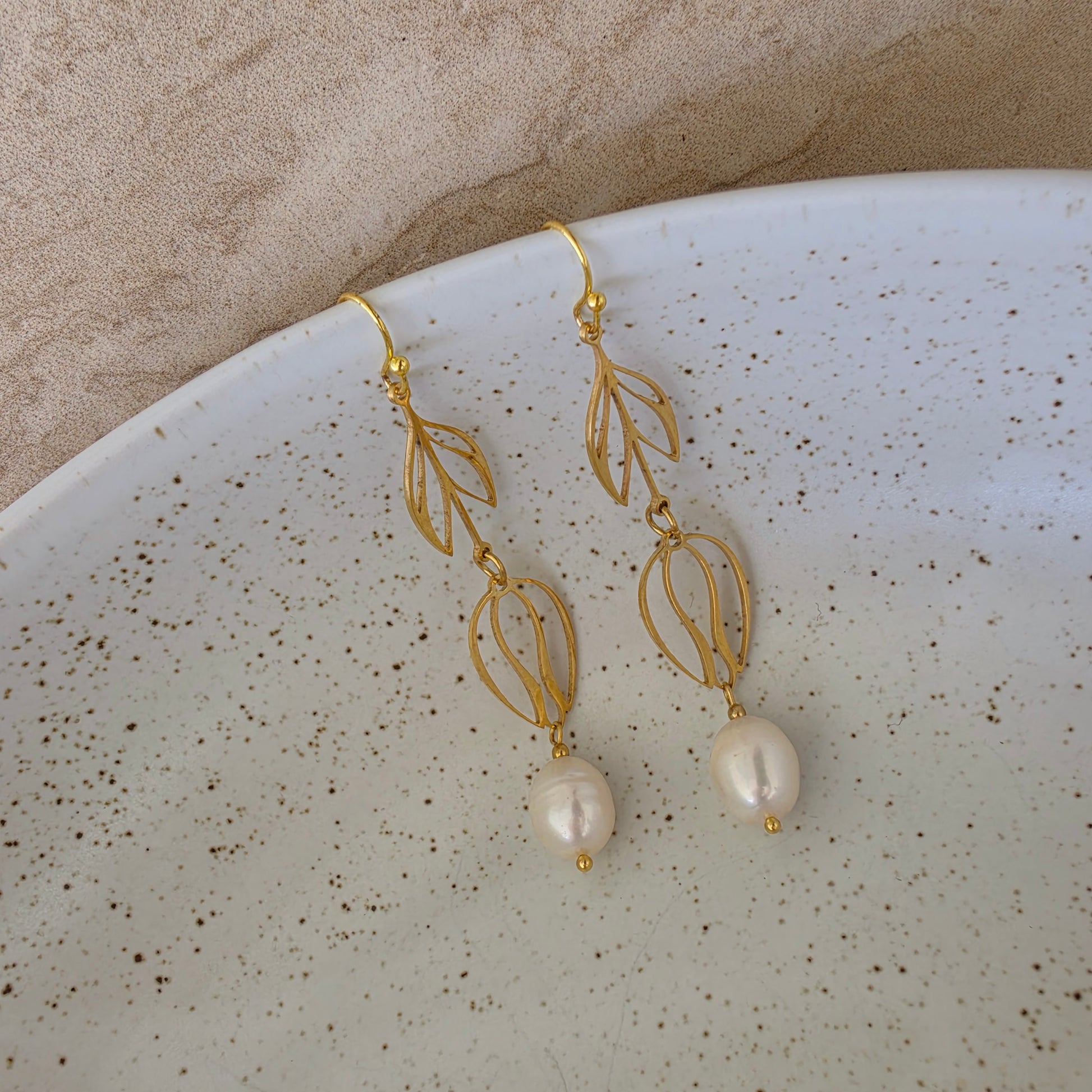 Top view of the Dew handmade pearl earrings showing the bright sheen and uniquely shaped pearls