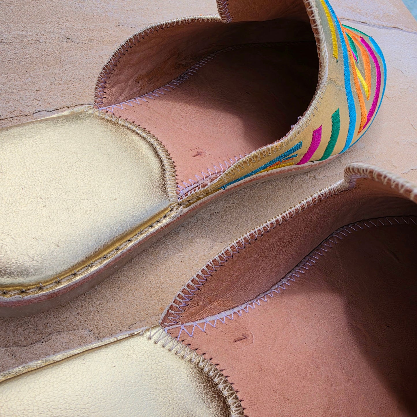 Image showing the gold heels and slight wear on the embroidered Moroccan inspired Diamond brand slides.
