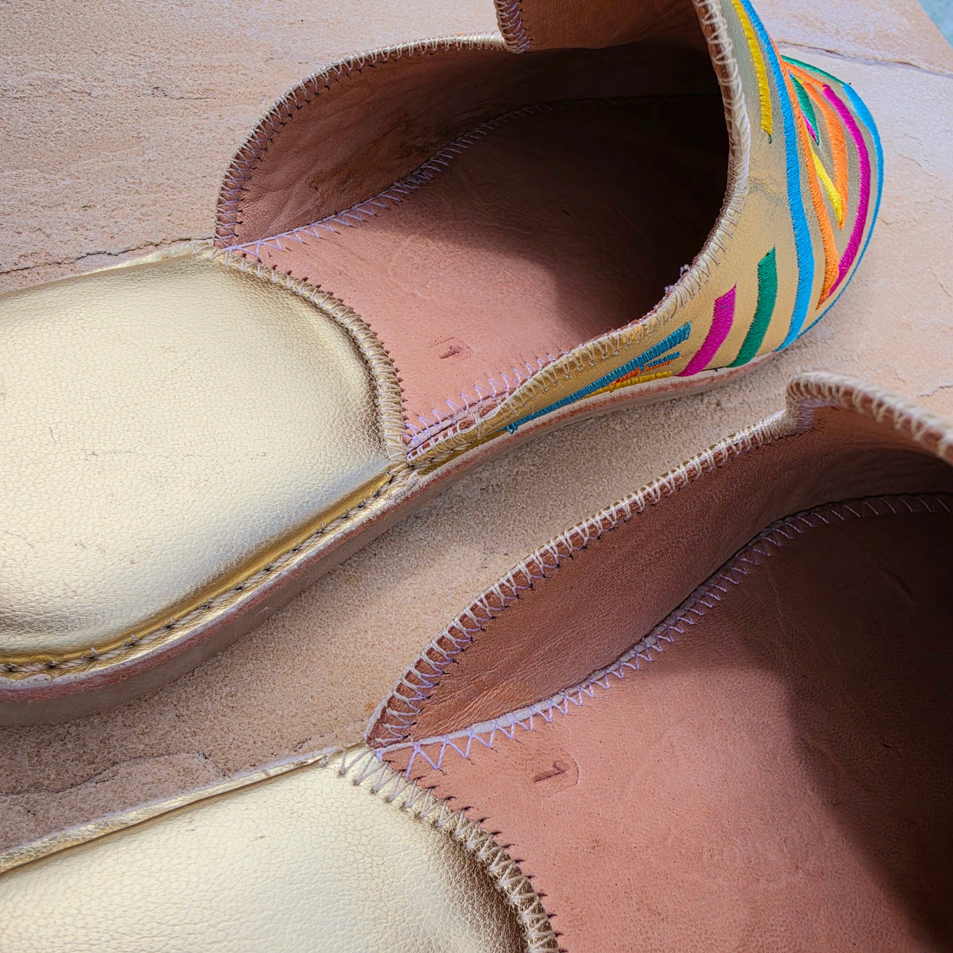 Image showing the gold heels and slight wear on the embroidered Moroccan inspired Diamond brand slides.