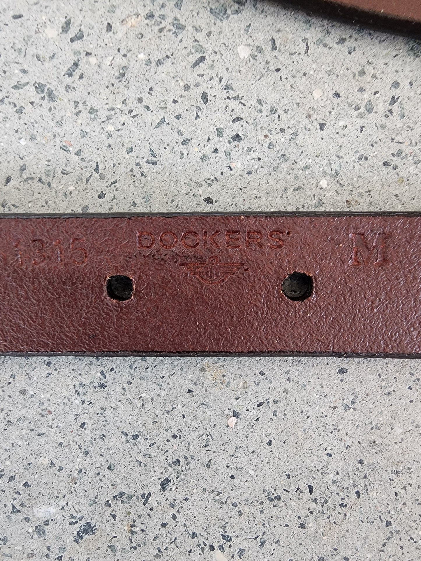 Close up of Dockers belt showing the brand imprint and size in the leather.