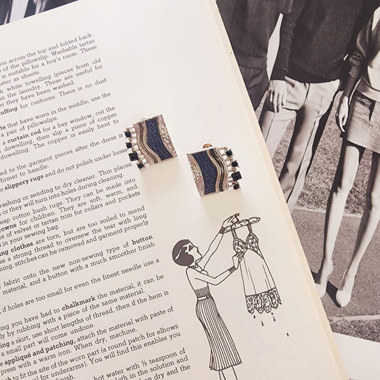 Square silver-tone Drift earrings with navy textured panel, front view