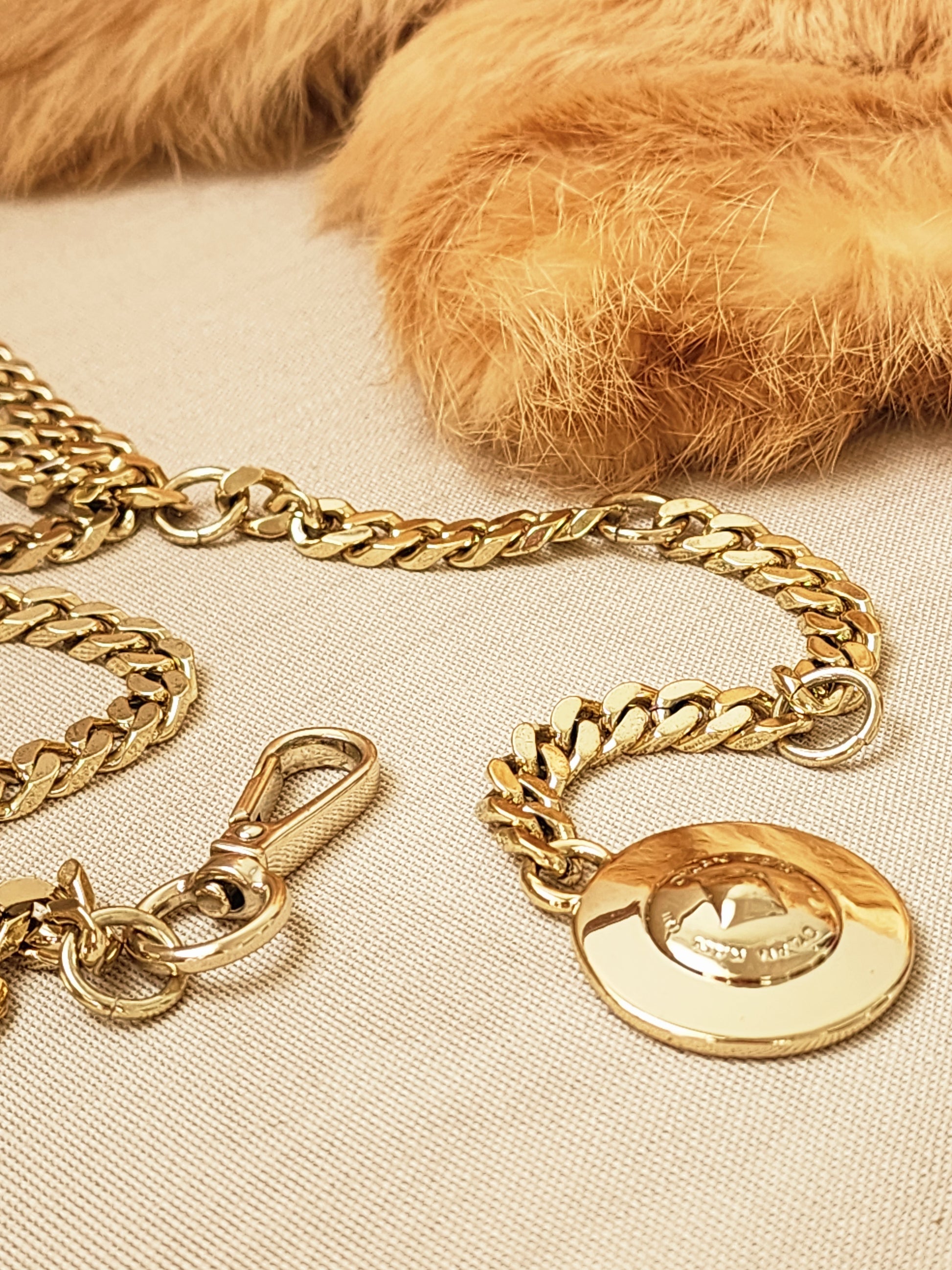 Dylan Kain gold chain belt clasp and fastening detail.