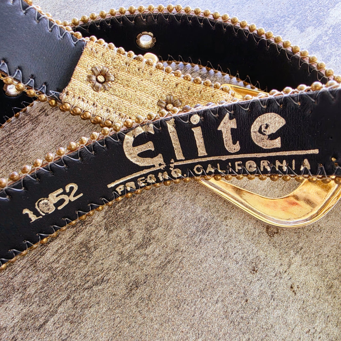 Elite Fresno California logo stamped on black leather backing vintage belt