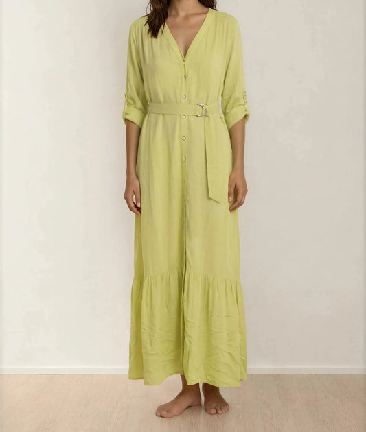Model showing the front of the Eva Kayan button up dress, matching belt and tiered hemline.