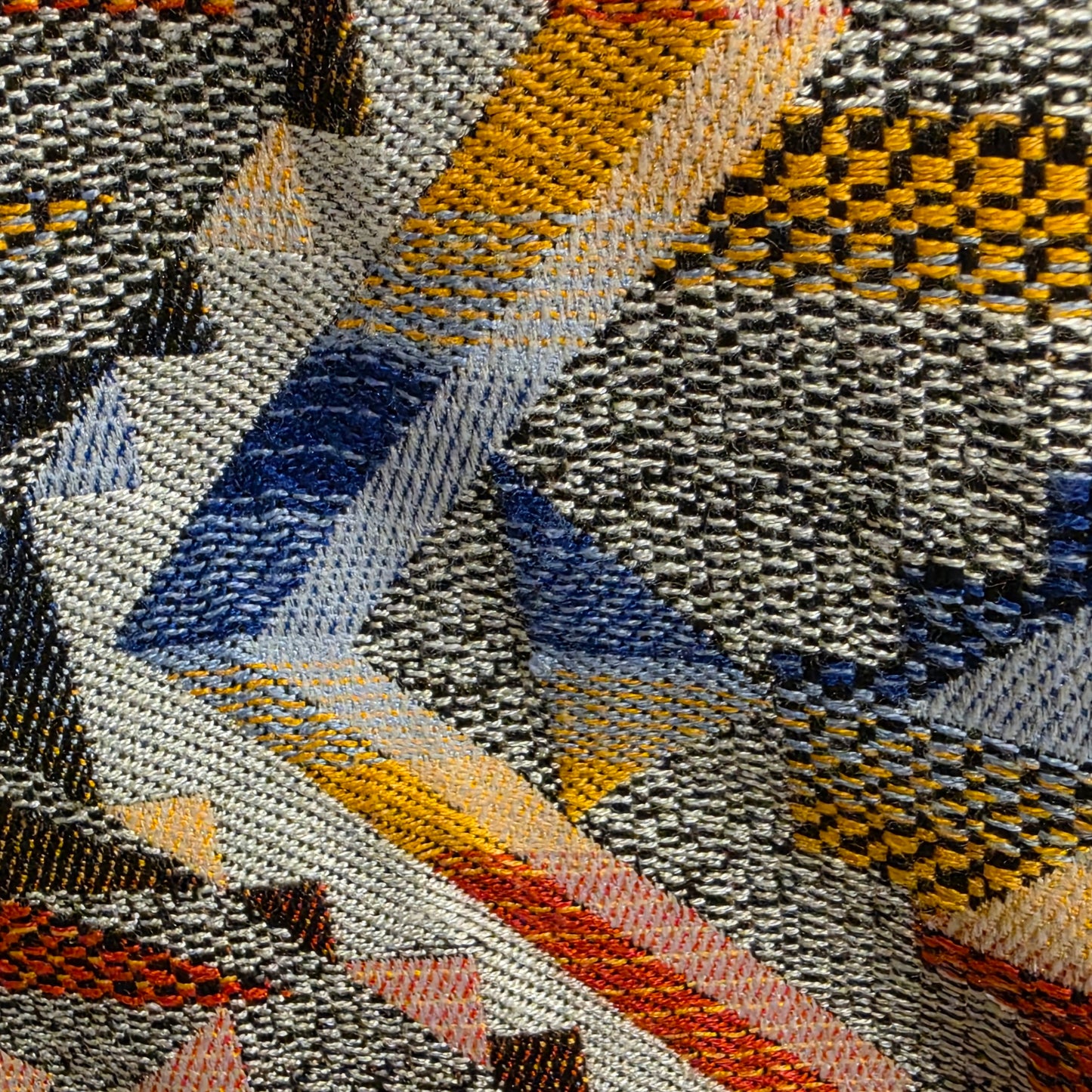 Close-up view of the textured fabric with geometric pattern on the FRNCH shift dress.