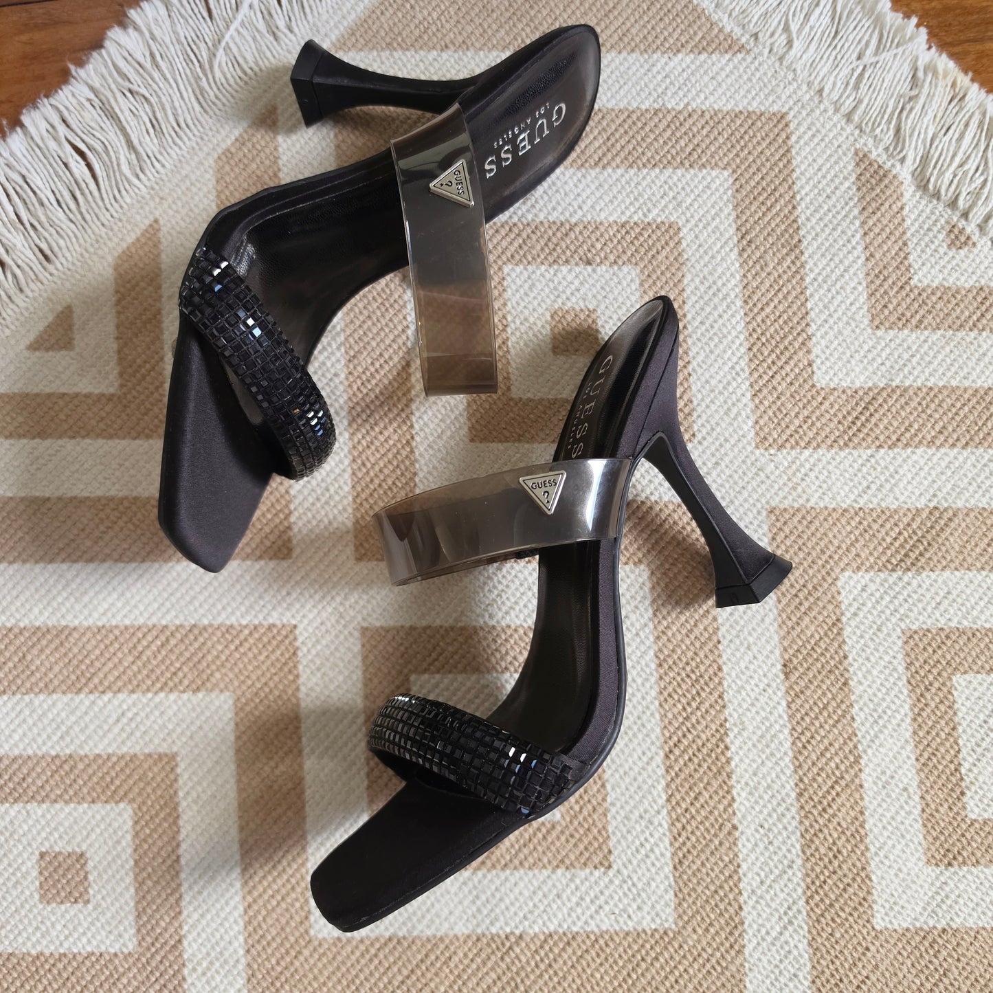 Black Guess heels with sculpted mid heel and transparent upper strap