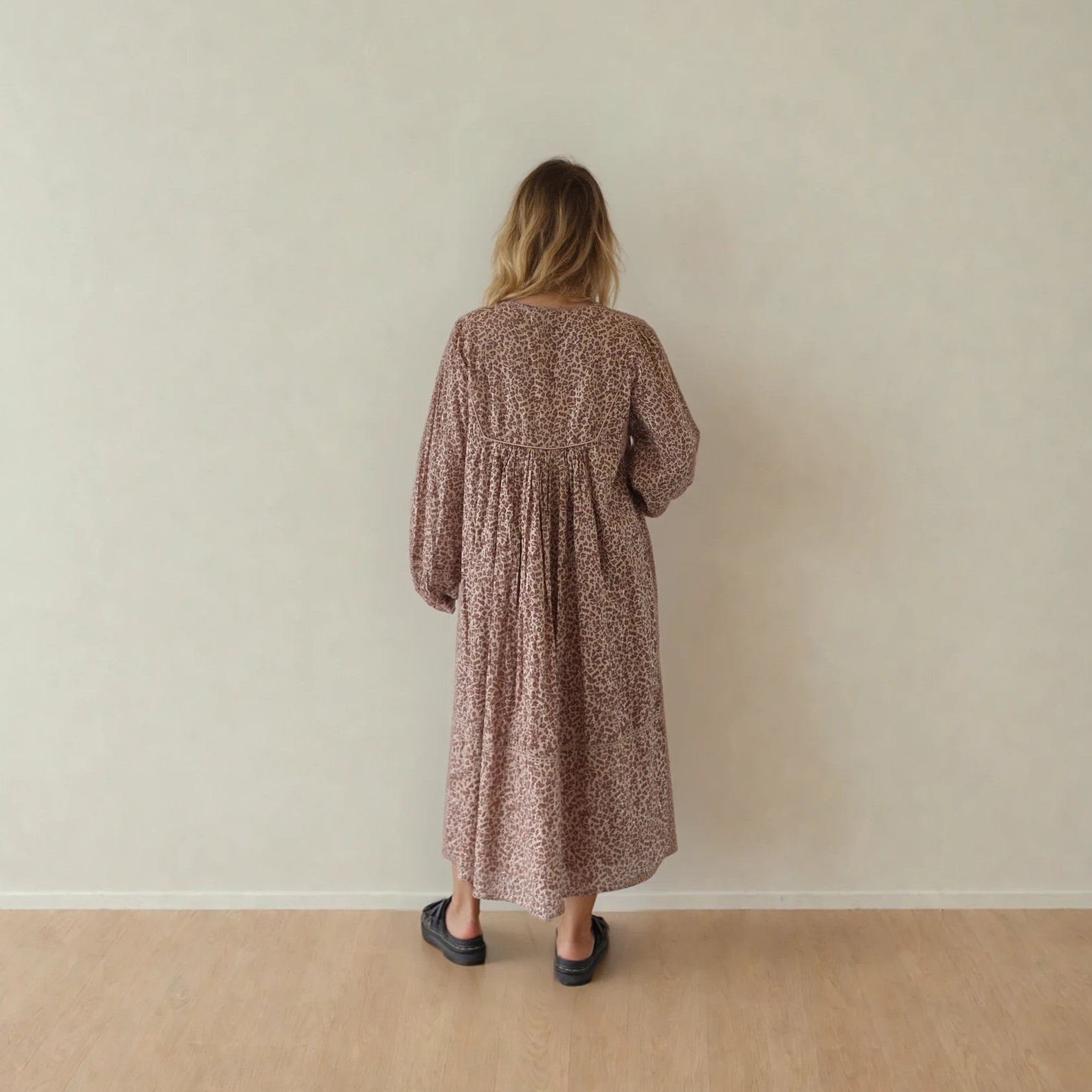 Image showing the back of a model wearing the House of Skye animal print midi dress