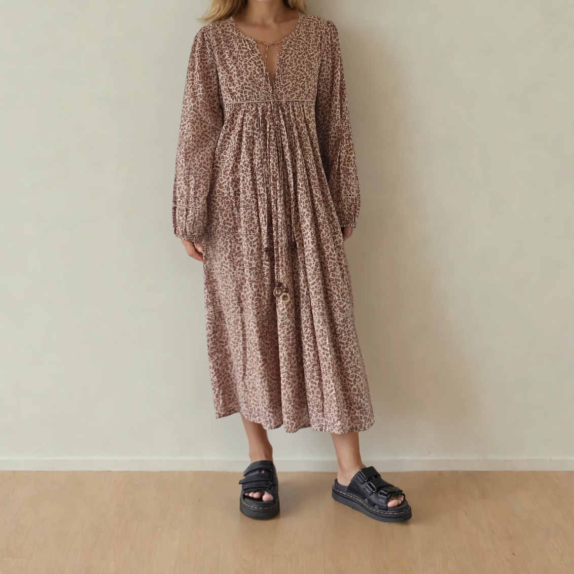 Image showing the front of the House of Skye animal print midi dress, showing the longer sleeve and beaded neck ties.