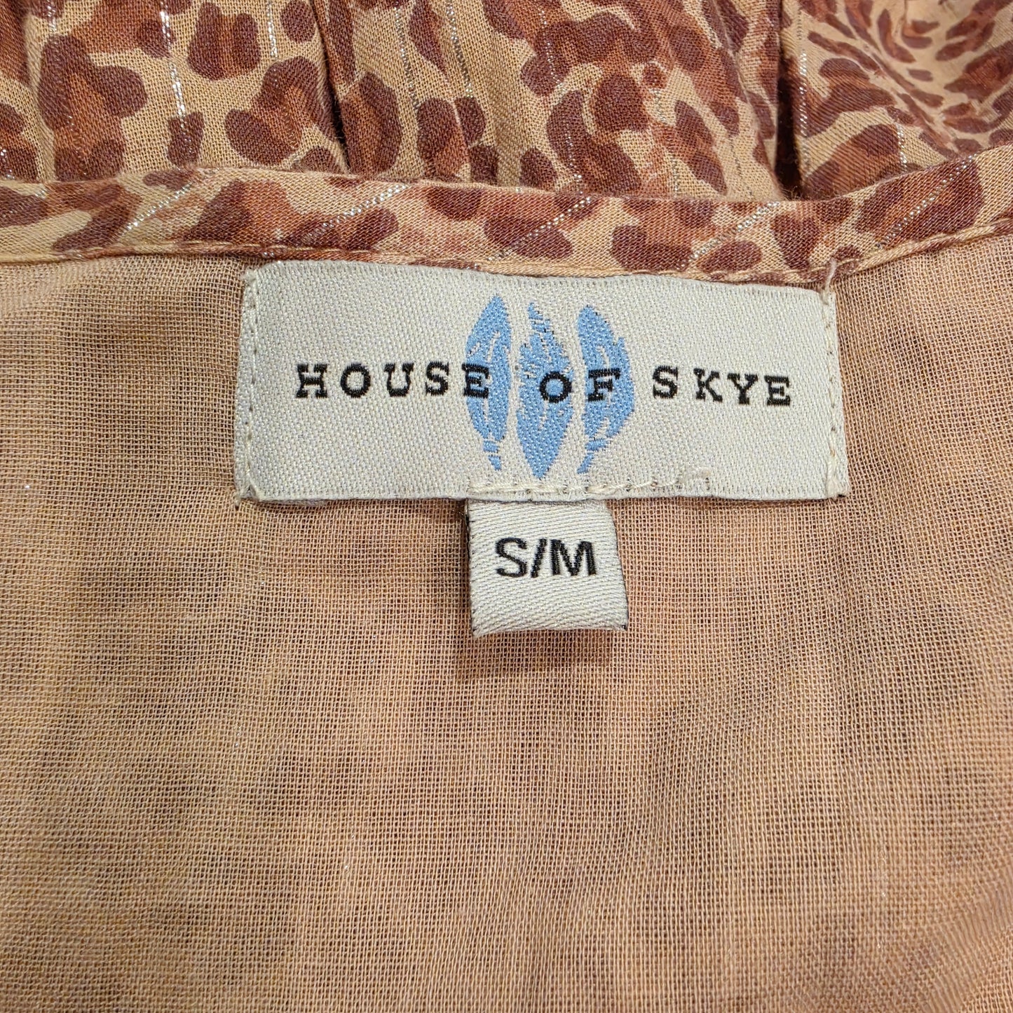 Image showing the brand label and size S/M on the House of Skye animal print dress