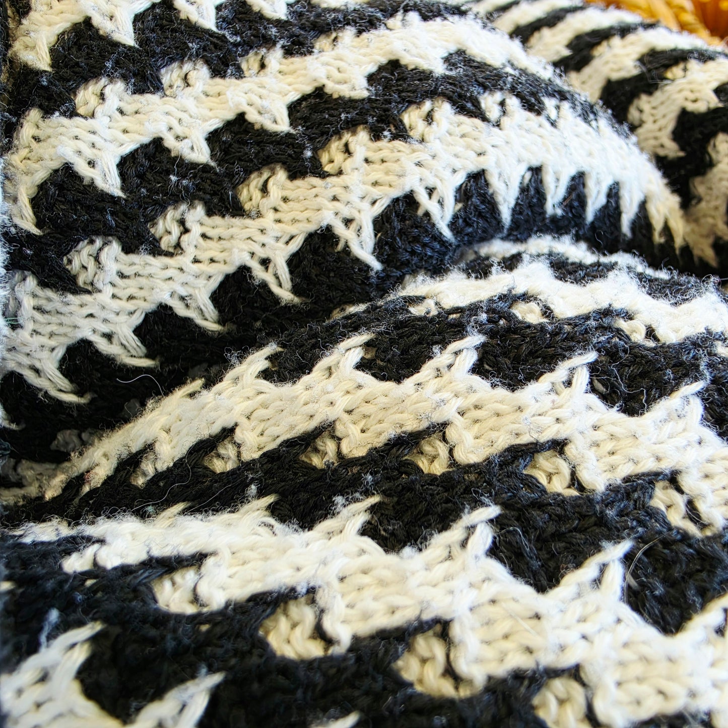 Close-up of the fabric of the Indi Luxe knit dress showing the light wear to the knitted weave.