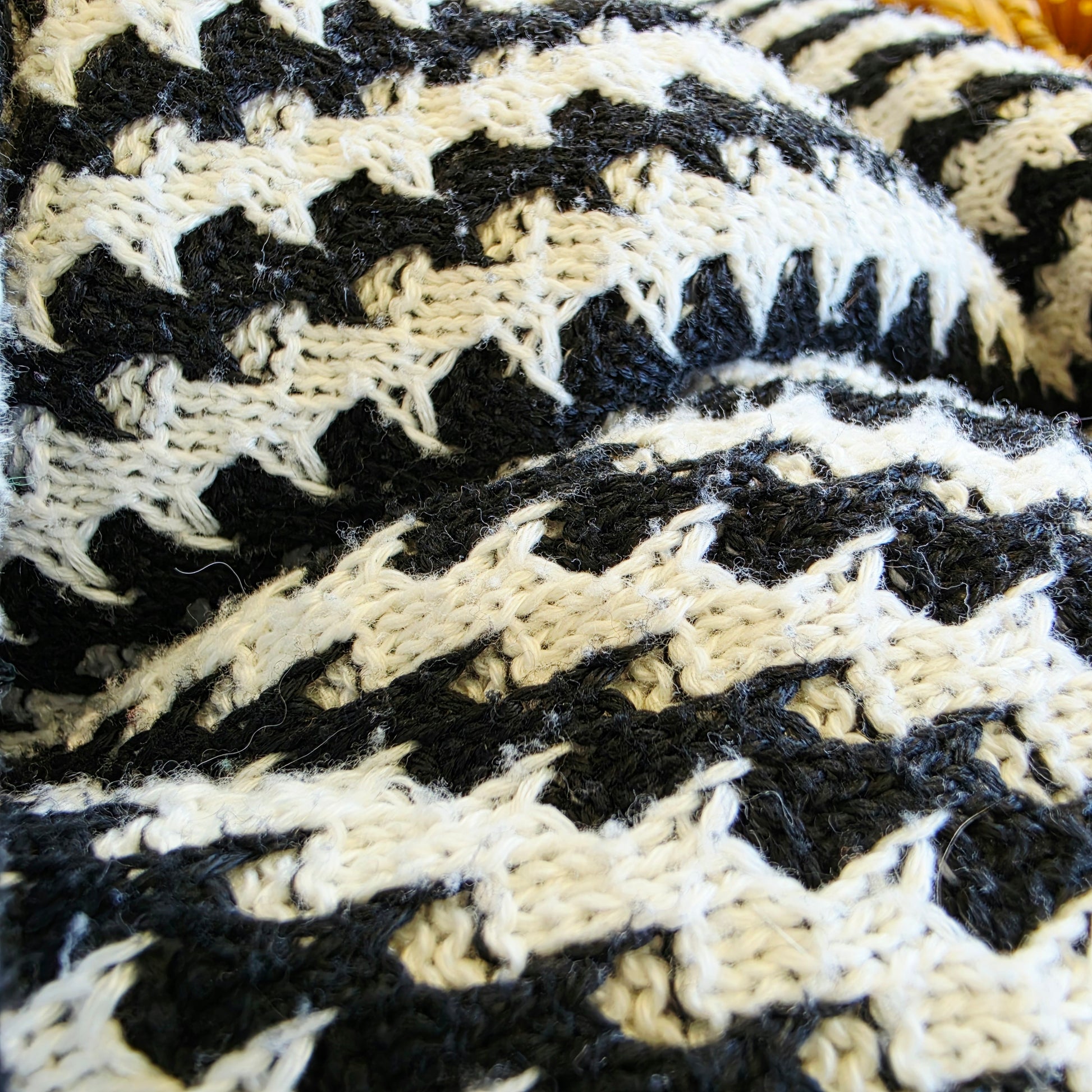 Close-up of the fabric of the Indi Luxe knit dress showing the light wear to the knitted weave.