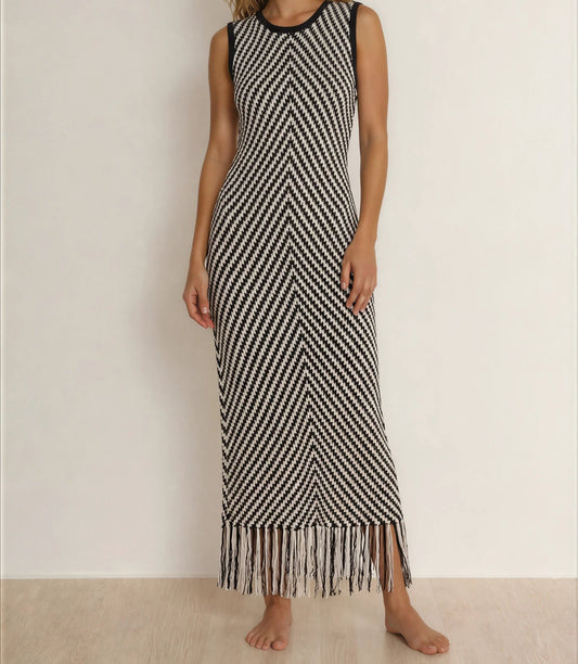 Model showing the front view of the Indi Luxe monochrome knit dress, showing the fringe hemline