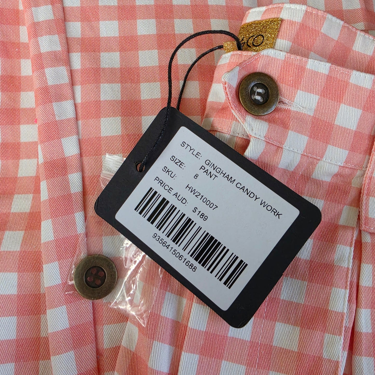 Close-up view of the tag on the Kip & Co. Candy Gingham Pants showing the original price of $189