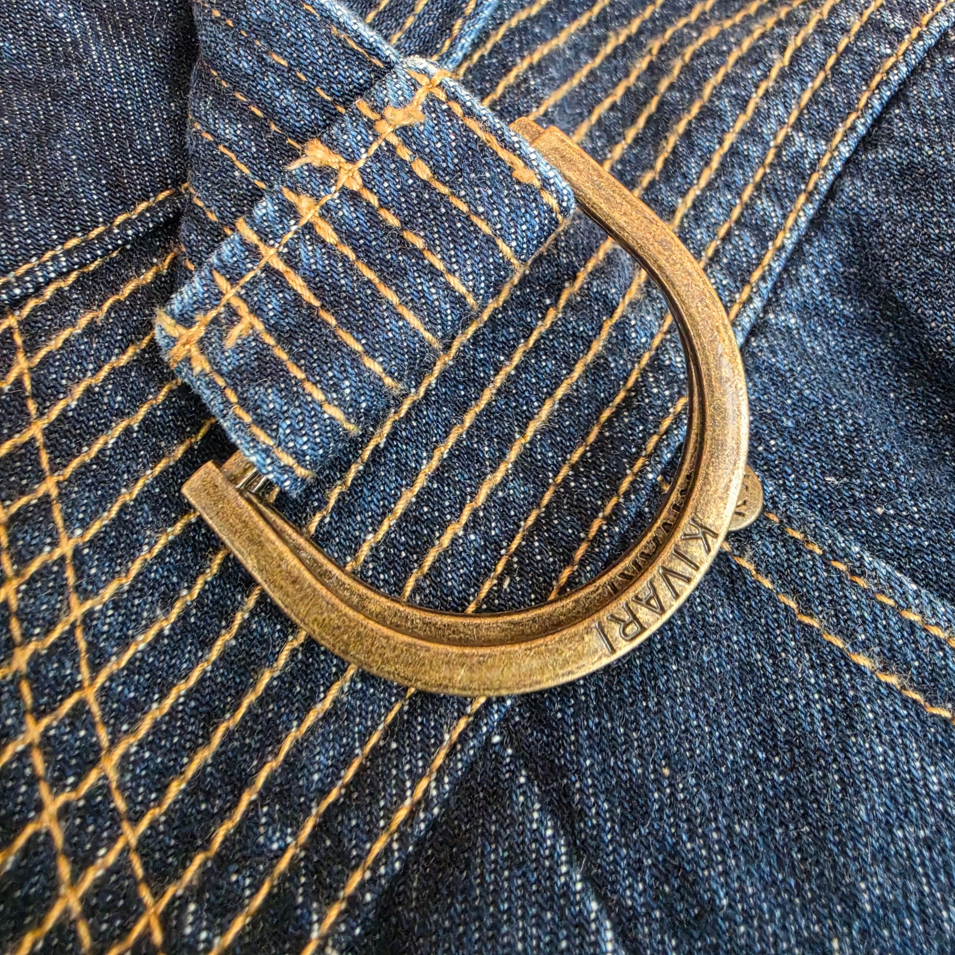 A close up view of the belt buckle detail on the Kivari Adina Jeans.