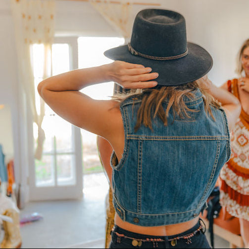 Model showing the back view of the Levis denim vest