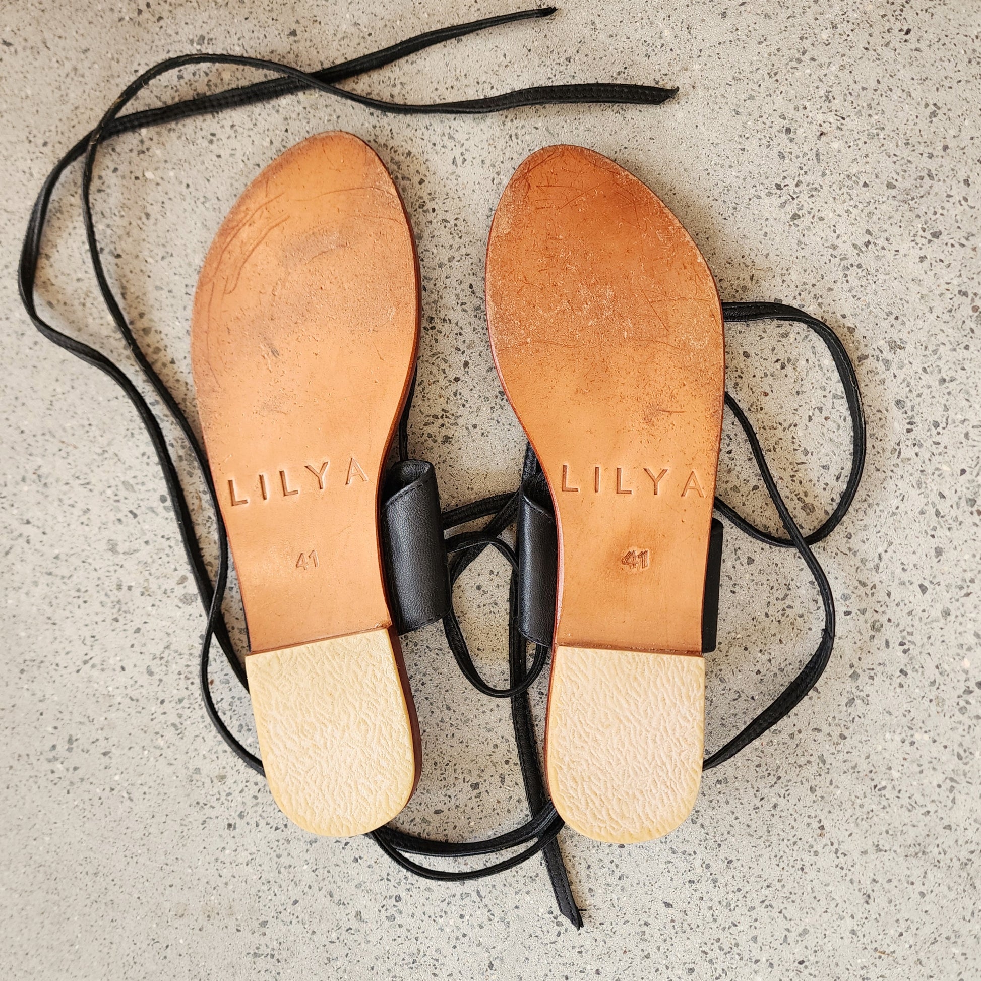 Underside of the Lilya leather sandals, showing light wear on the sole.
