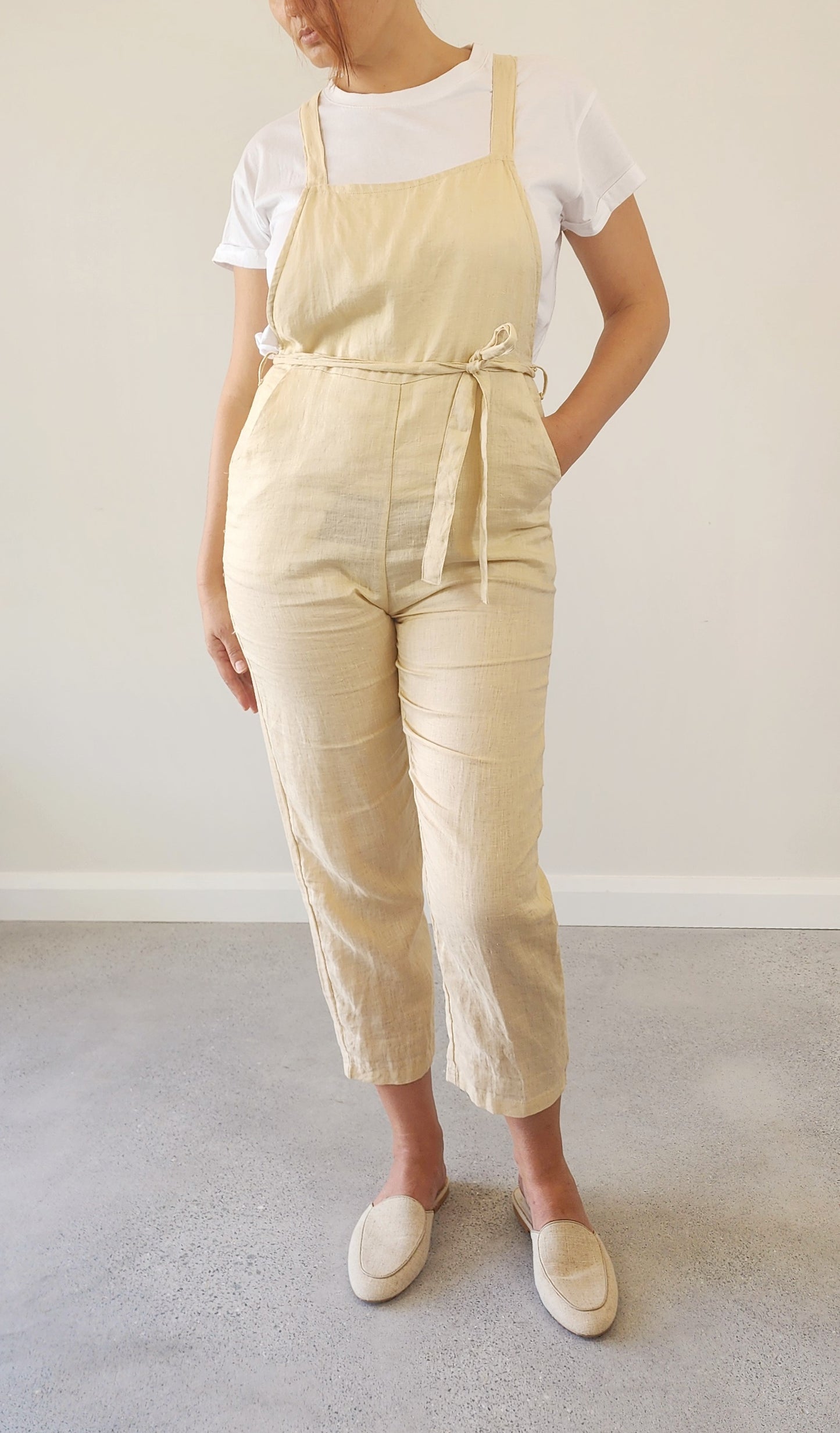 Front view of Lilya oatmeal linen overalls in size M, showing relaxed fit and soft linen texture.