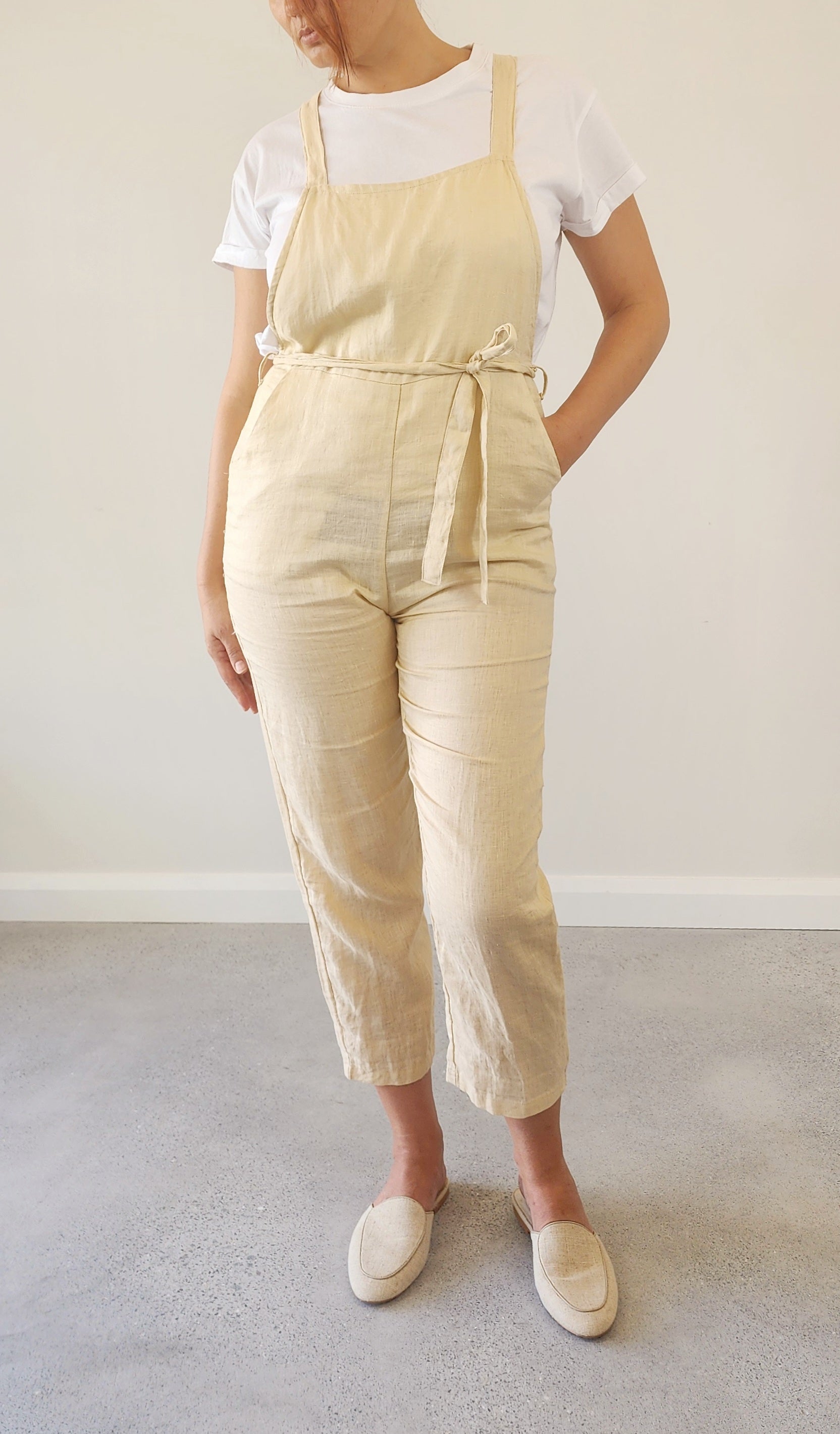 Front view of Lilya oatmeal linen overalls in size M, showing relaxed fit and soft linen texture.