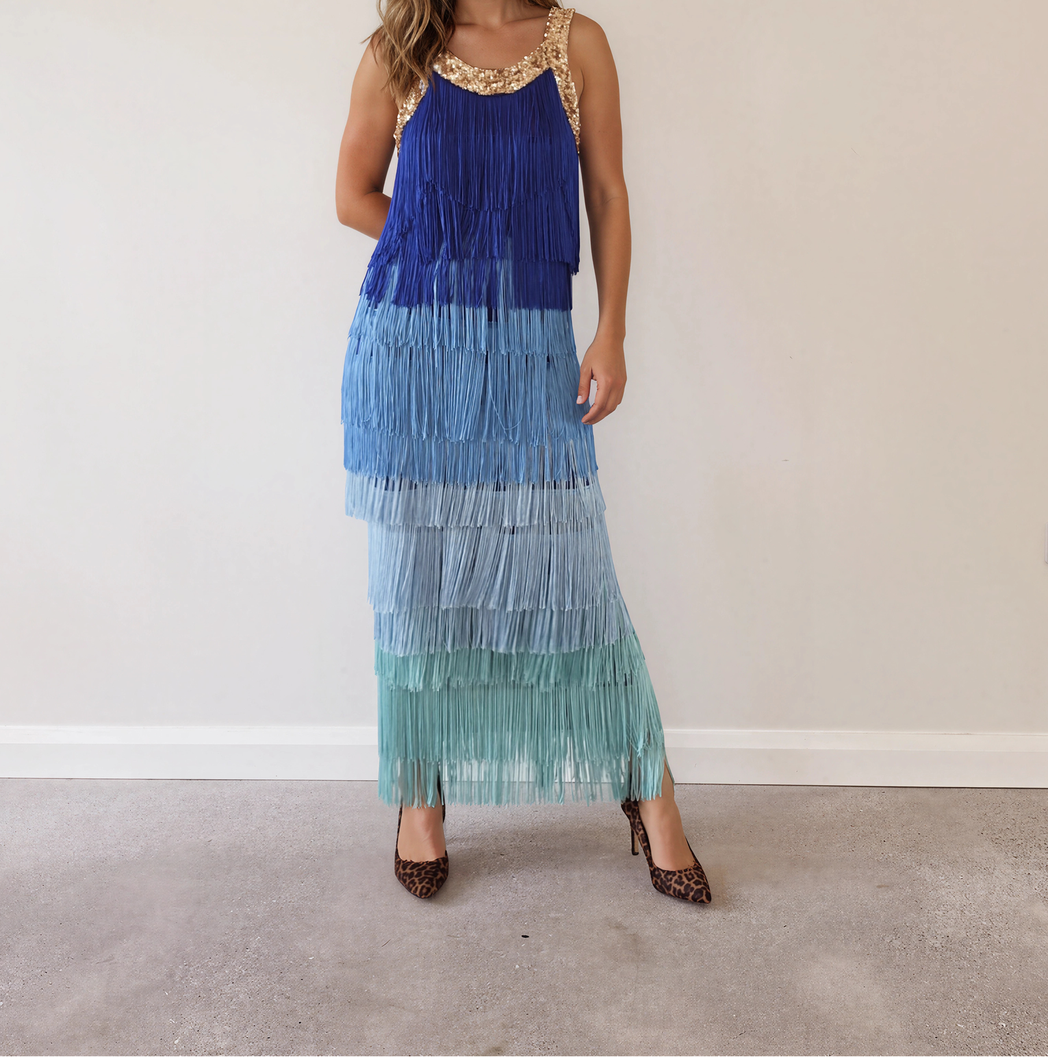 Image showing model wearing the Love Bonfire The Label Jewel Skies fringe midi dress with gold sequin neckline and blue ombré tassels.