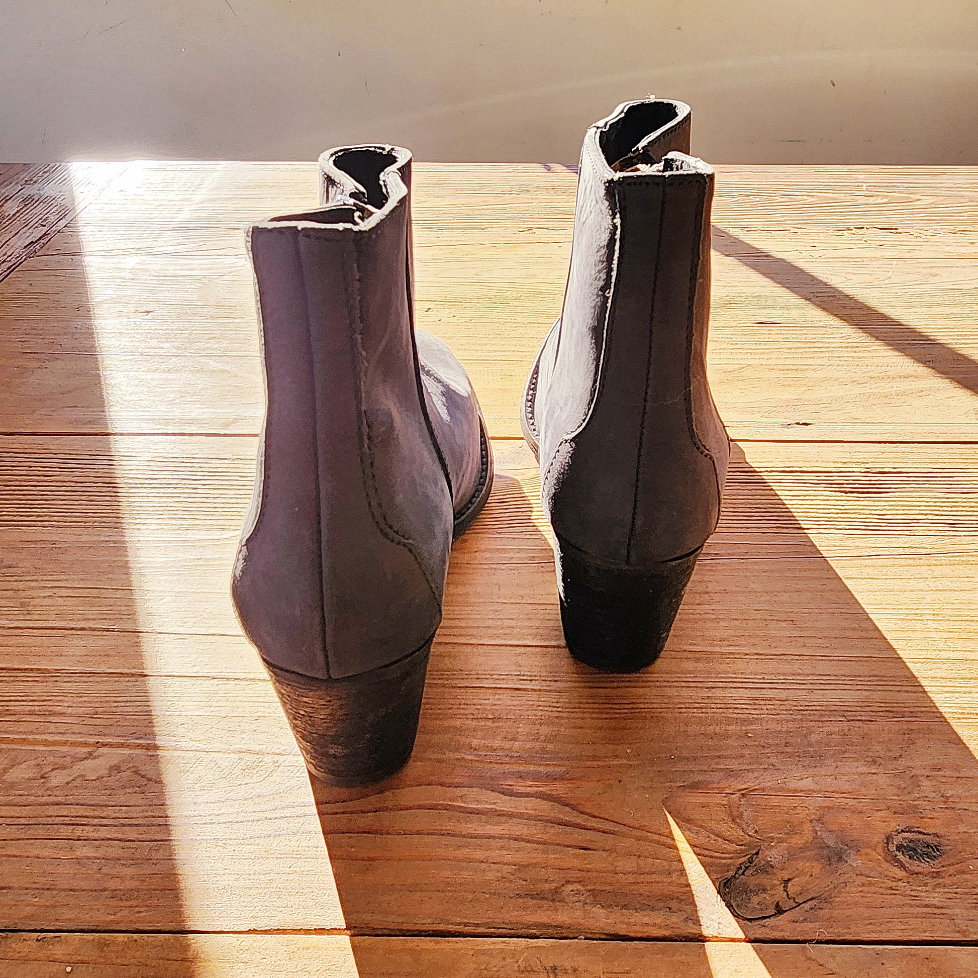 Back view of the grey suede Maya McQueen boots, highlighting the heel and rear seam detail.