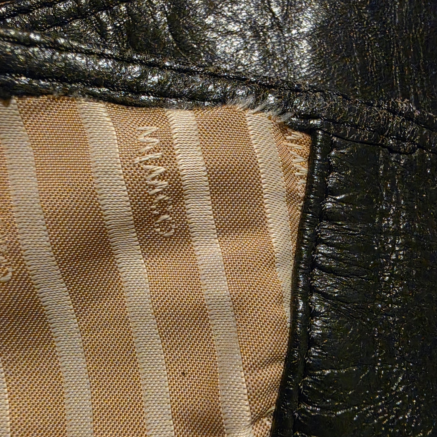 Close up view of the lining on the wide leather Mimco belt showing a small area where the lining is coming away from the stictching.