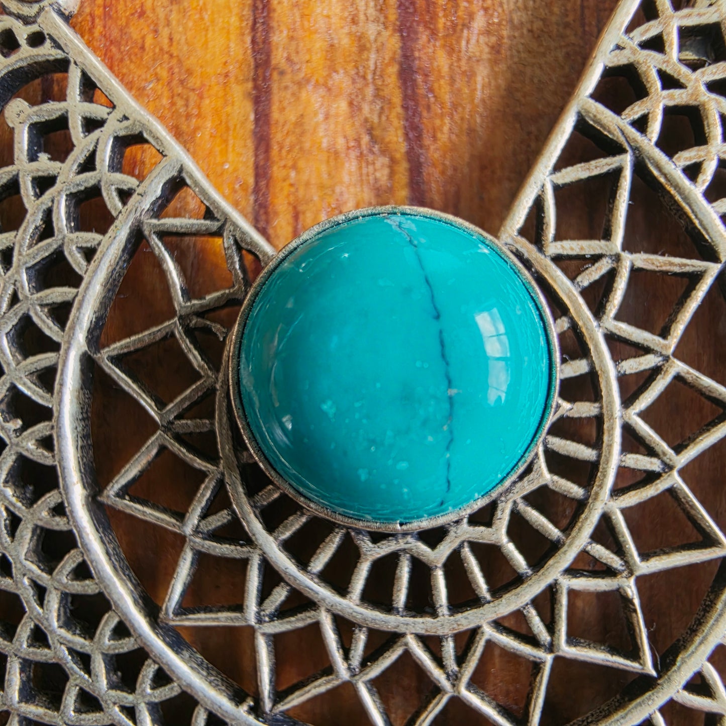 A close up view of the turquoise look cabochon on the Mirage Filigree 