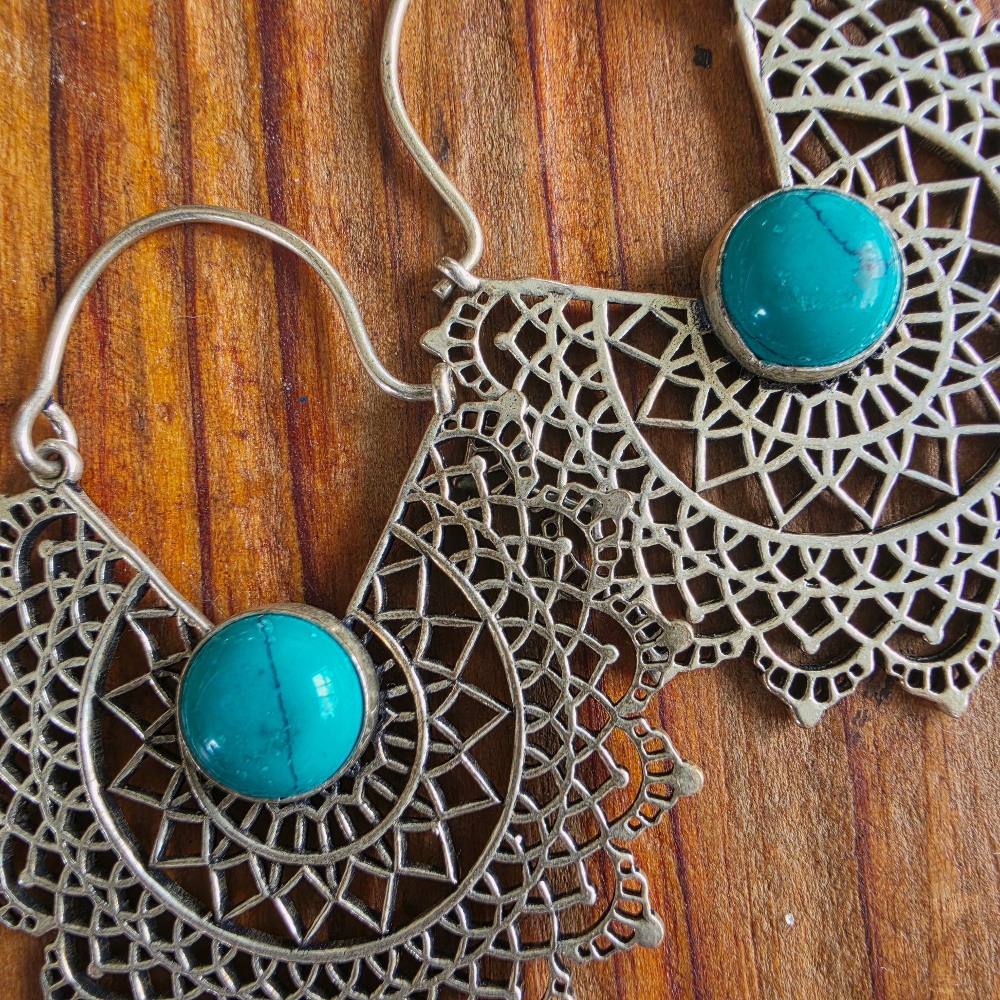 Image showing the Detailed filigree pattern with turquoise-look centre stone on the Mirage earrings