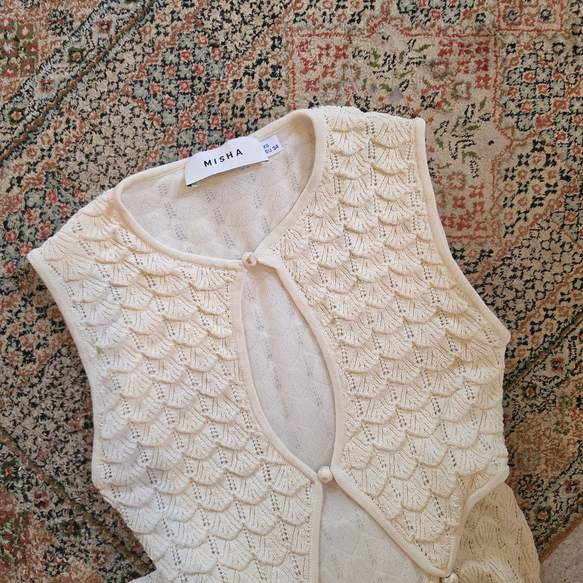 Close up view of the Misha Esther Dress showing the pointelle knit, cut out style and decorative beads