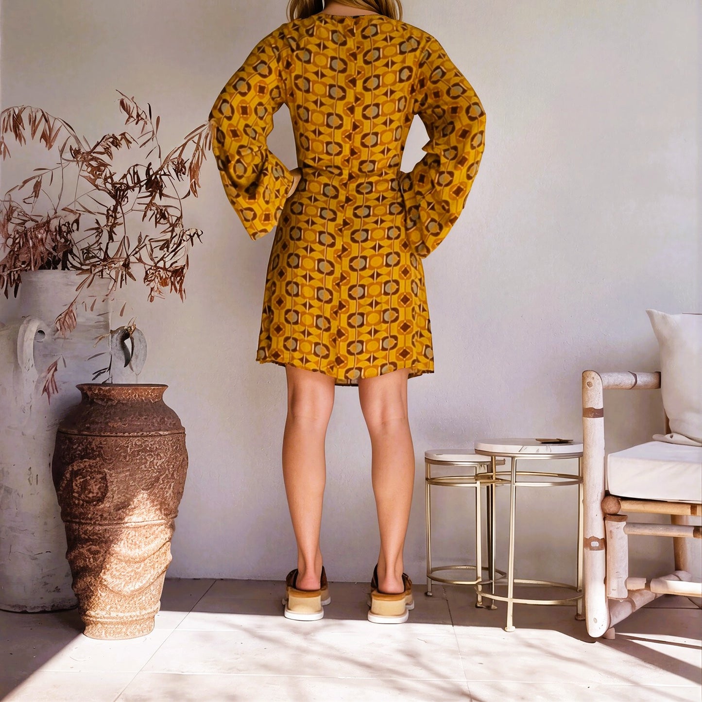 Back view of model wearing the Nine Lives Bazaar Quincey Mini Dress in retro print, with long bell sleeves