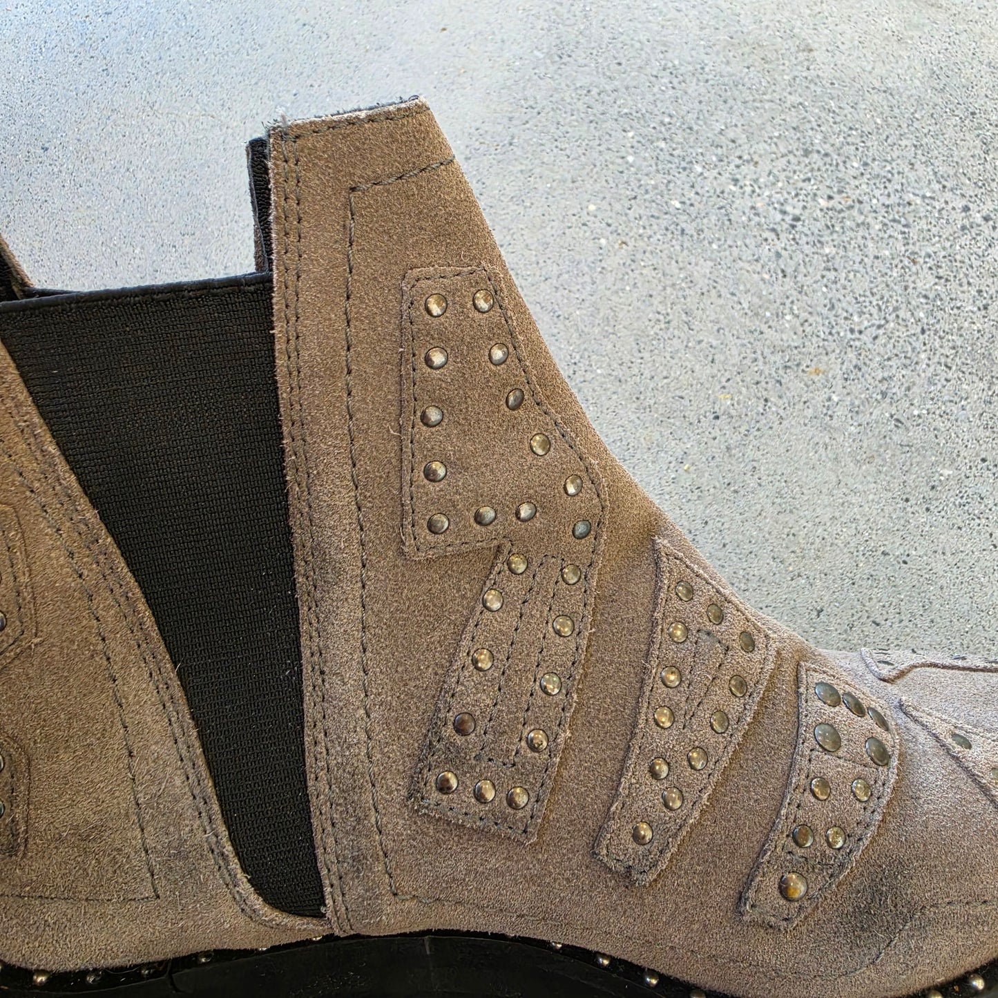 Close-up of elastic side panel and worn suede on One Teaspoon ankle boots