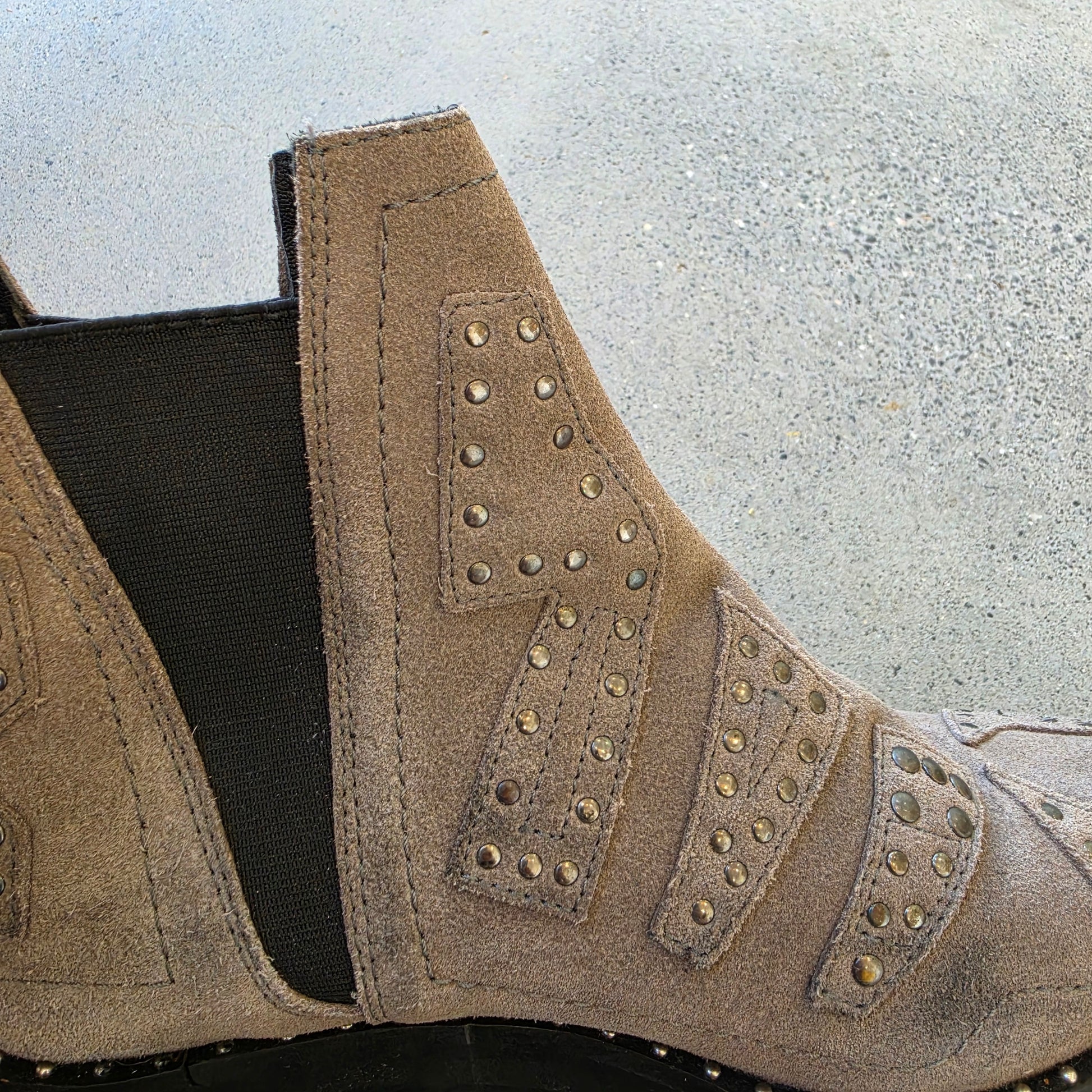 Close-up of elastic side panel and worn suede on One Teaspoon ankle boots