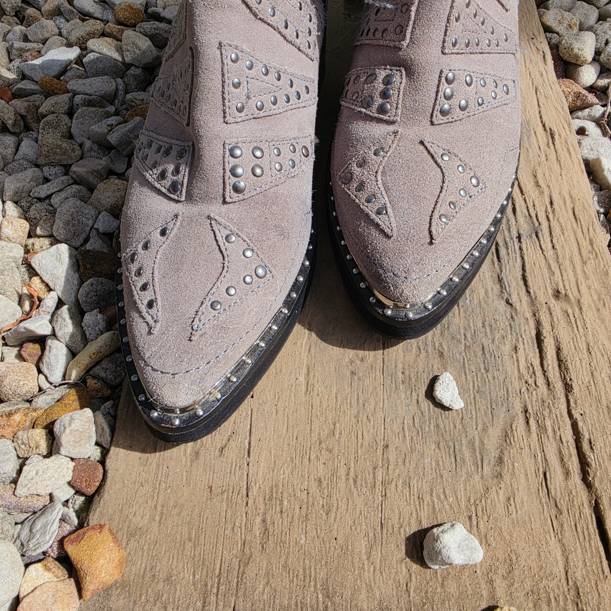 Pointed toe detail of suede One Teaspoon boots with studded western pattern