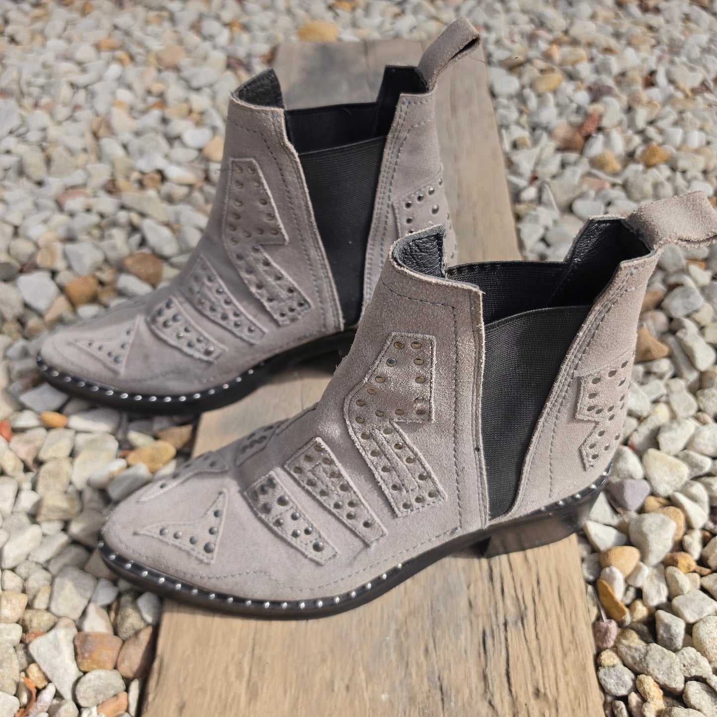 Side profile of taupe suede One Teaspoon ankle boots with studs and elastic panels