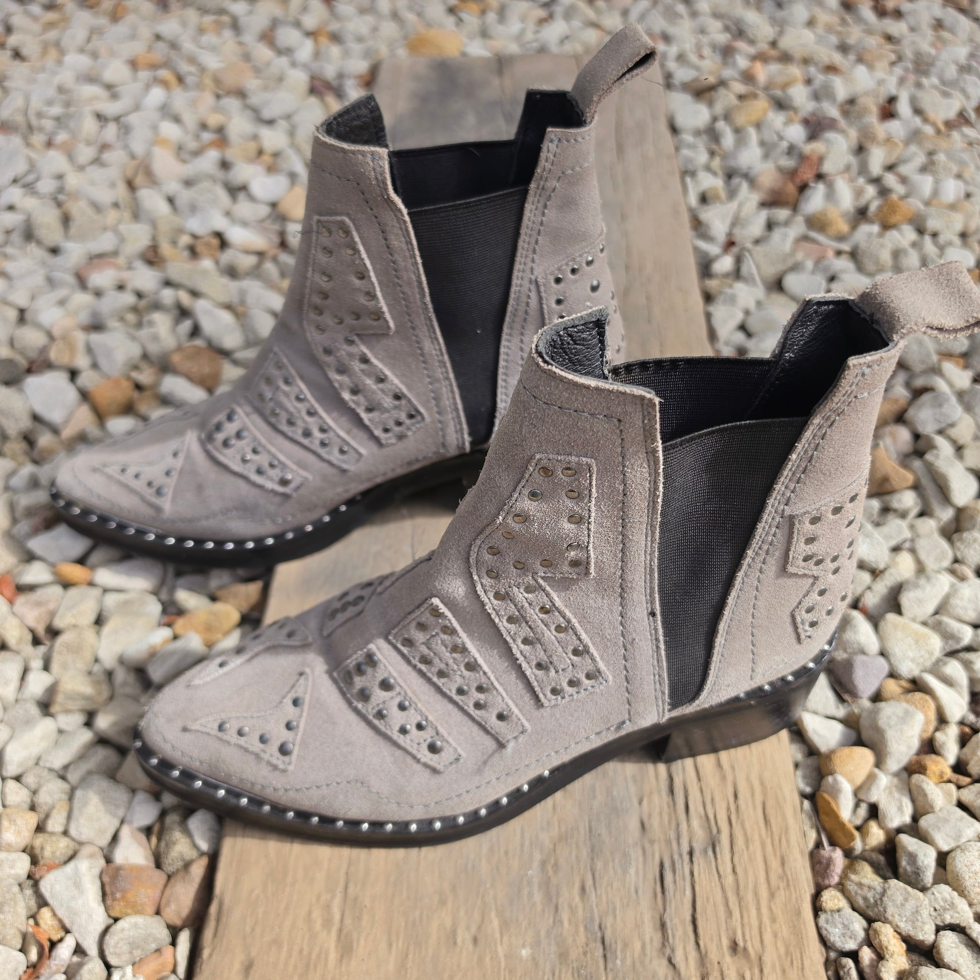 Side profile of taupe suede One Teaspoon ankle boots with studs and elastic panels