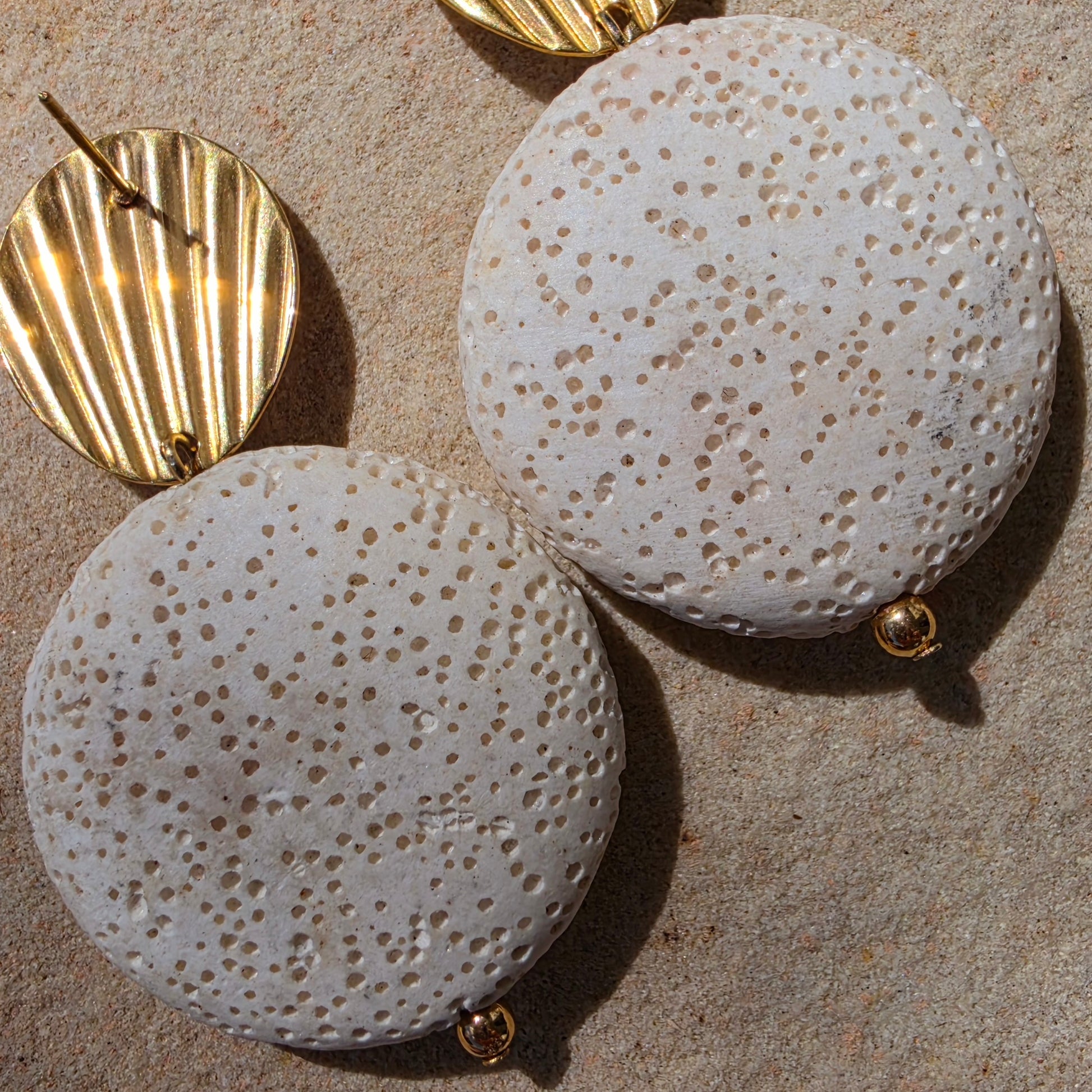 Close up view of the Relic Lumen earrings showing the discolouration from age.