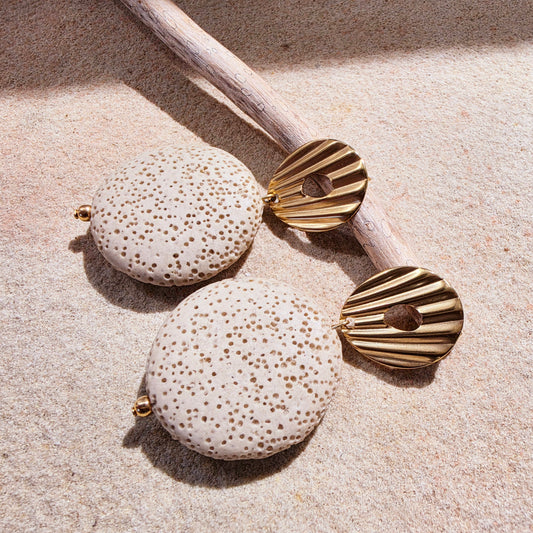 Image of the Lumen earrings from the Relic collection, showing the coral like texture and gold plated closure details.