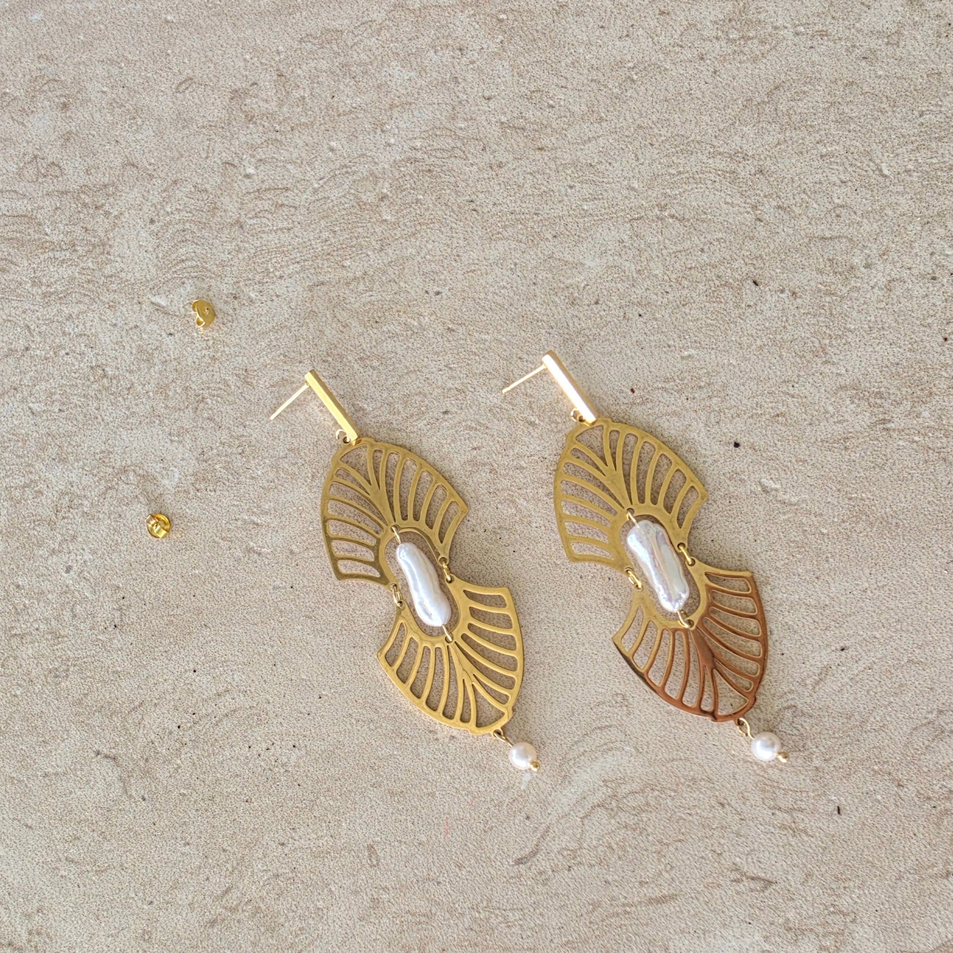 Top view of the Ripple handmade pearl earrings showing the statement center pearl and gold plated components