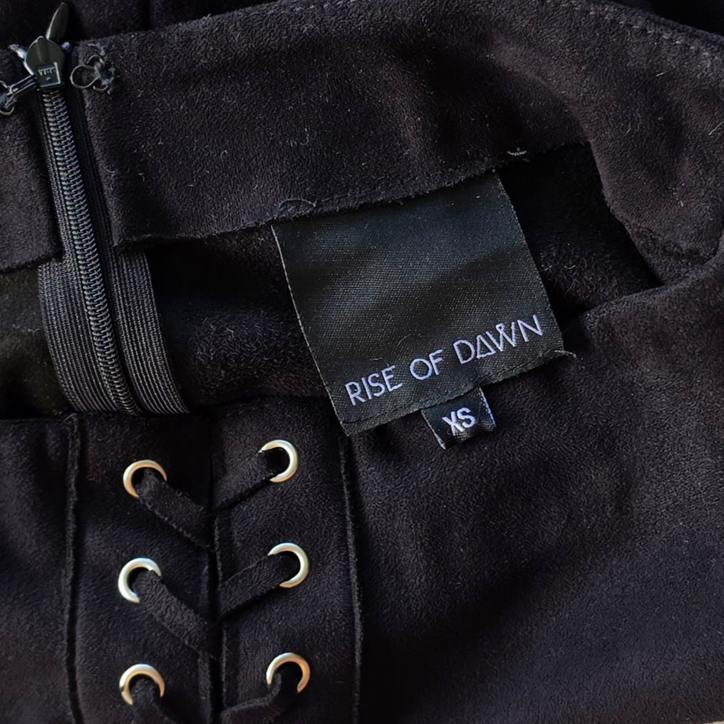 Close of view of the Rise of Dawn fringe mini skirt showing the brand label.