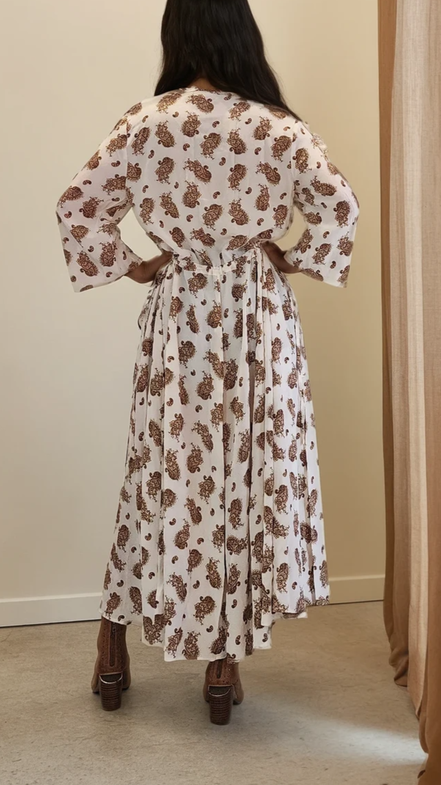 Back view of silk ruffle dress, showing cinched waist, with flowy skirt movement.