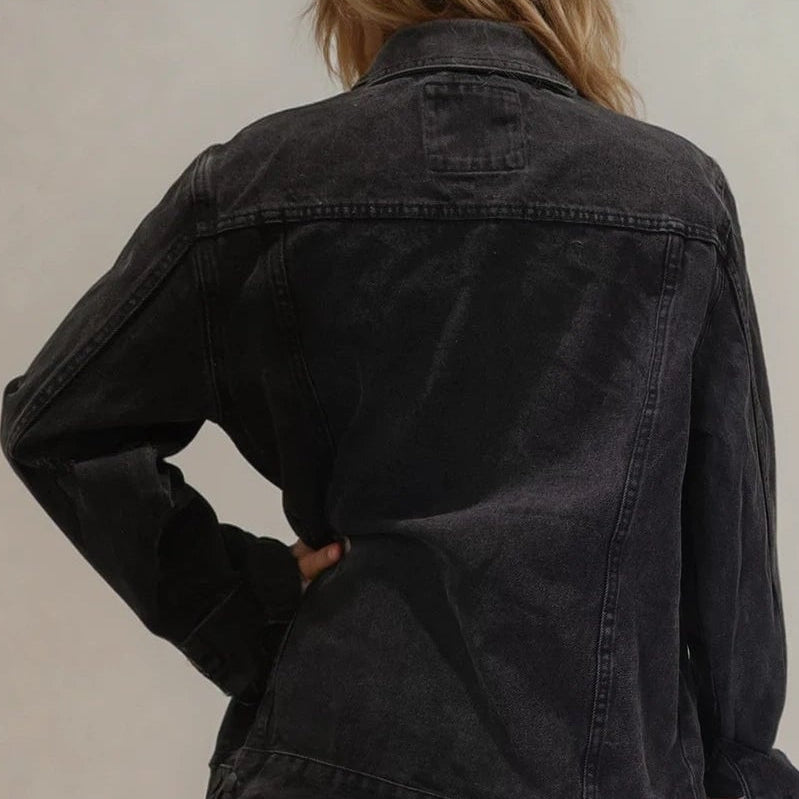 Back view of black RVCA denim jacket with worn-in fading and relaxed fit