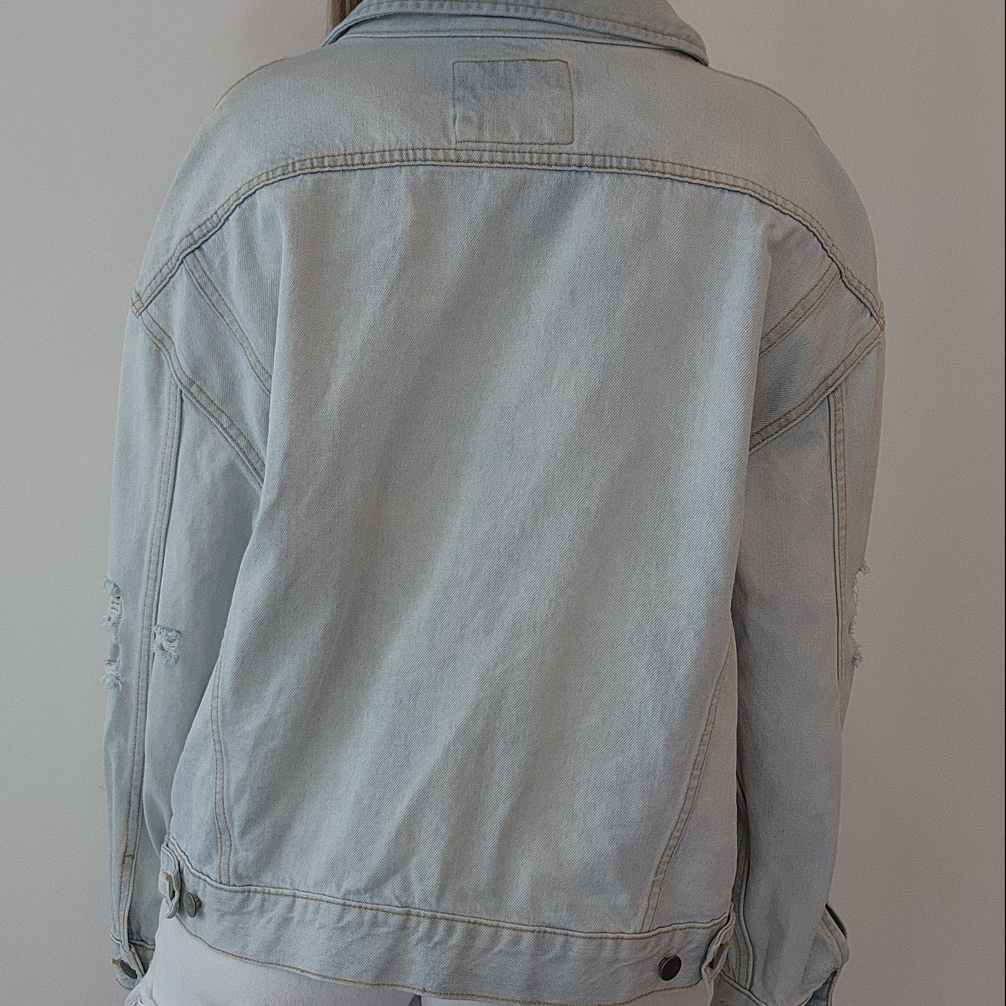 Back view of RVCA denim jacket, showing the relaxed cut and adjustable tabs.