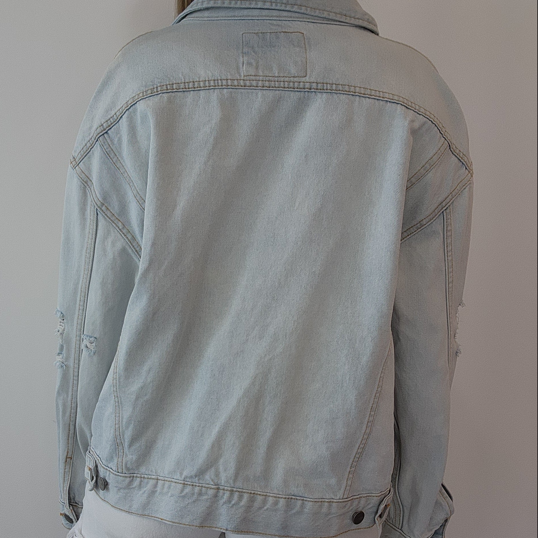 Back view of RVCA denim jacket, showing the relaxed cut and adjustable tabs.